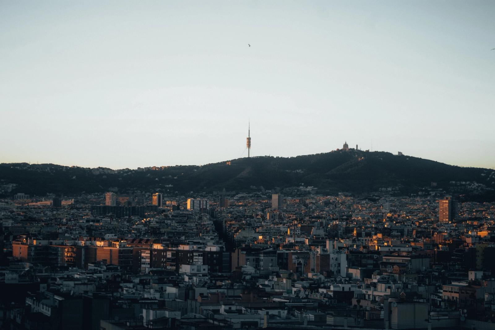 Stunning view of Barcelona with Collserola Tower silhouetted against the evening sky