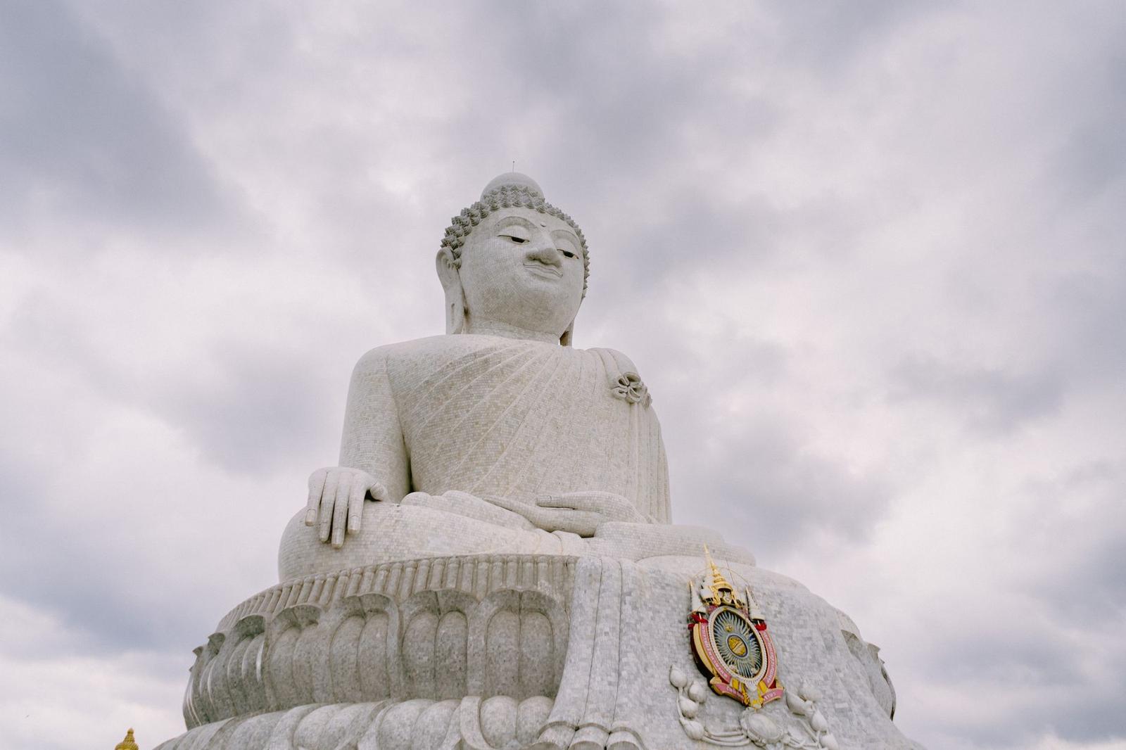 Captivating perspective of the iconic Big Buddha statue in Phuket, Thailand against a cloudy sky