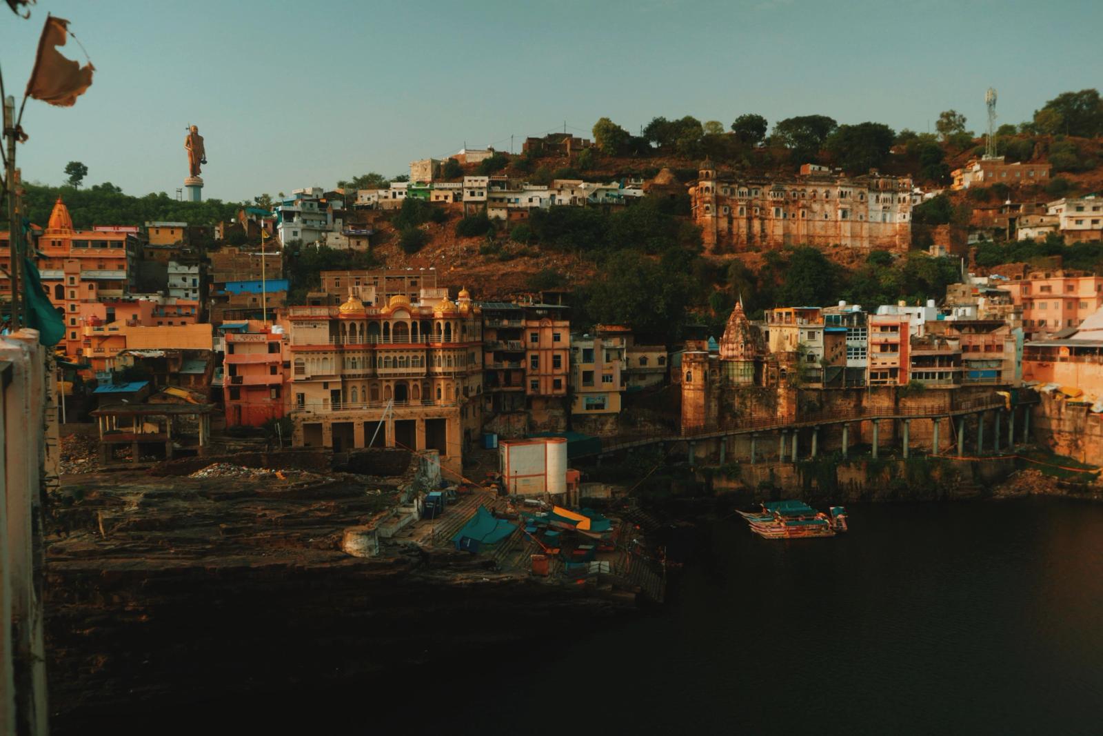 Colorful Indian townscape with river and vibrant architecture at dusk; perfect for cultural exploration