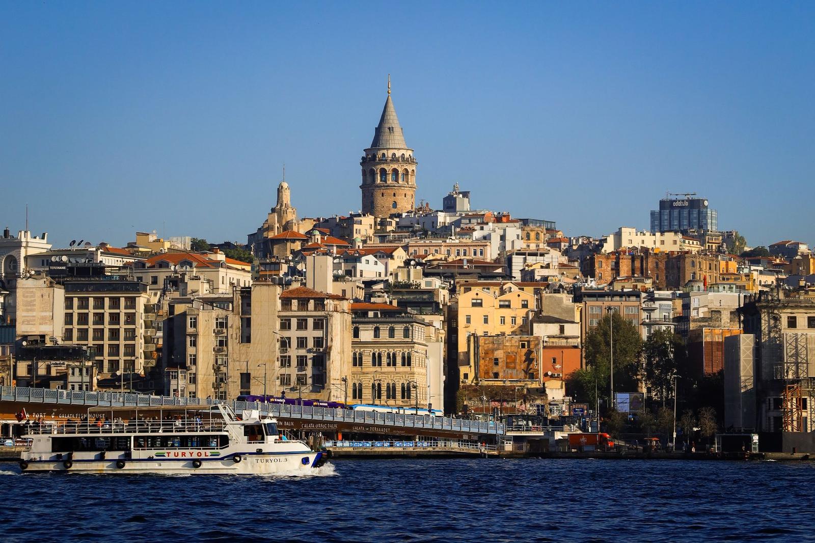 Capture the stunning view of Istanbul's iconic Galata Tower and vibrant cityscape along the Bosphorus