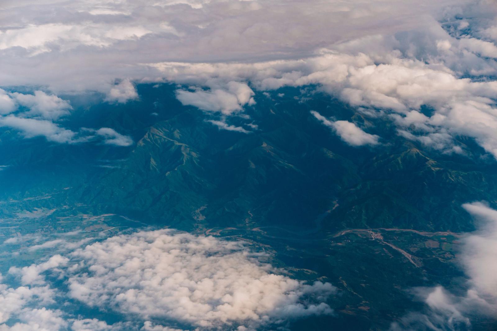 Captivating aerial photograph of mountains covered by clouds, showcasing natural beauty