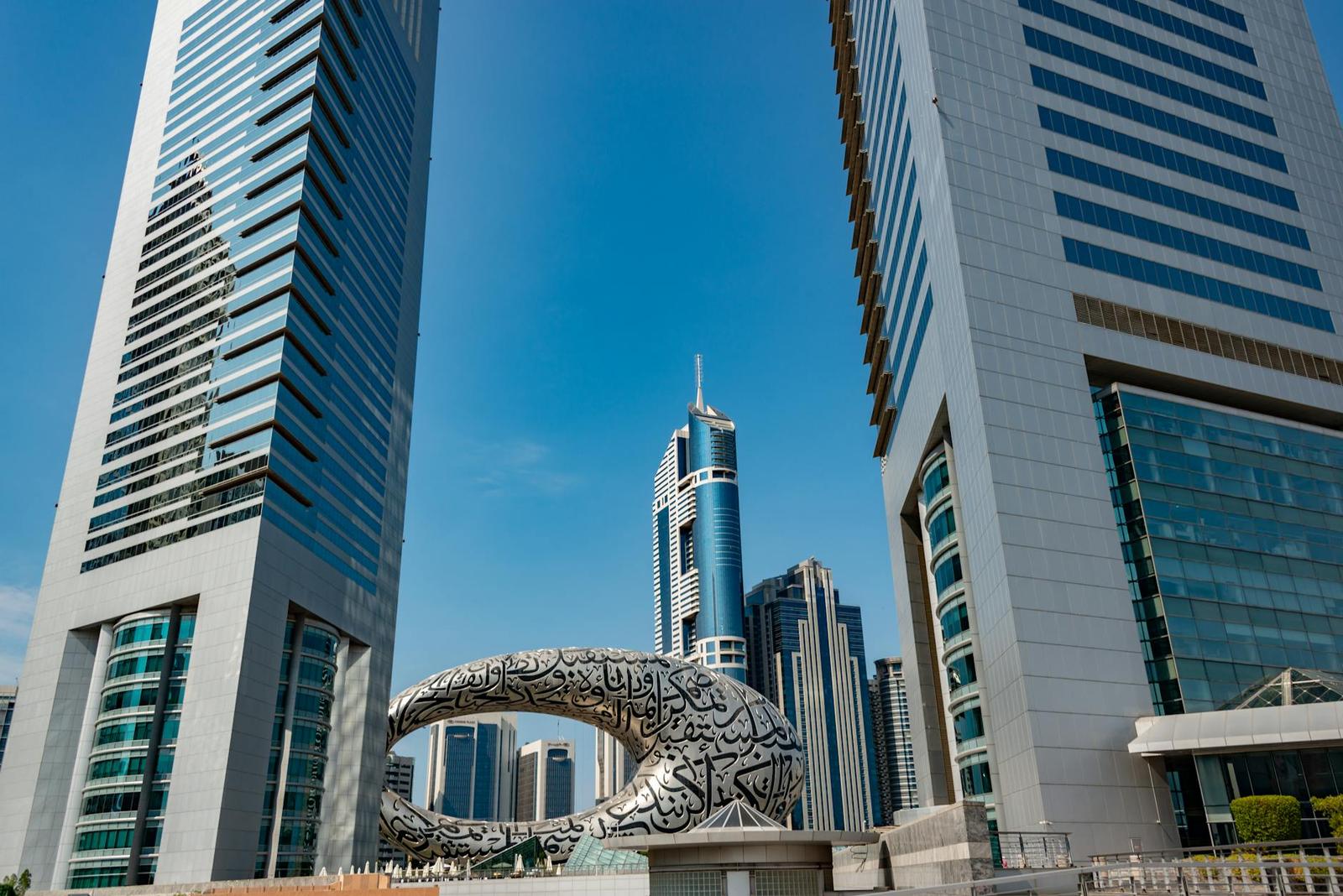 Discover the futuristic architecture amidst Dubai's towering cityscape under a clear blue sky
