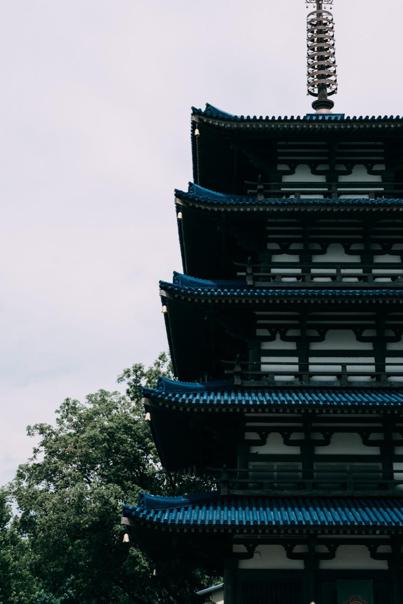 Elegant vertical view of a Japanese pagoda with blue roofs in Epcot