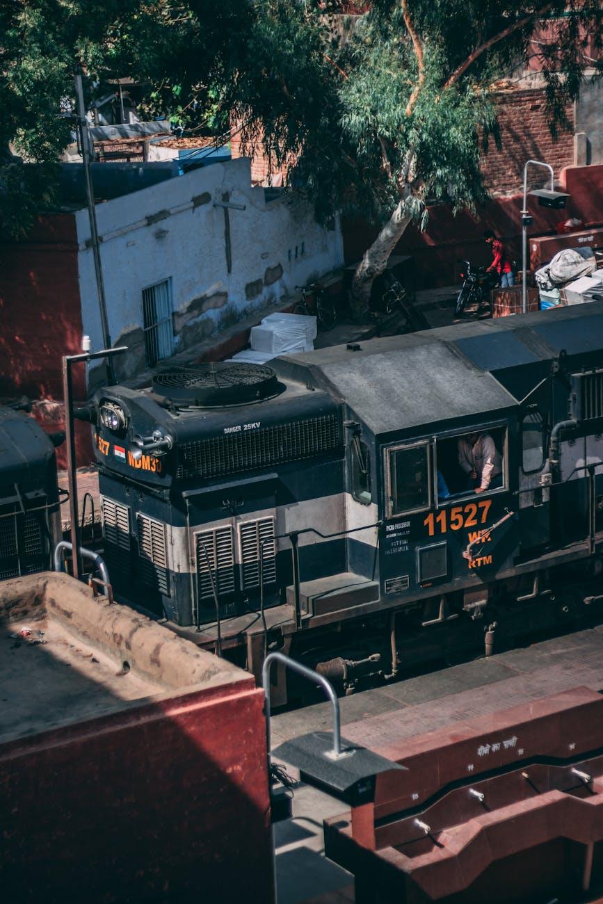 Diesel locomotive parked beside a narrow trackside street