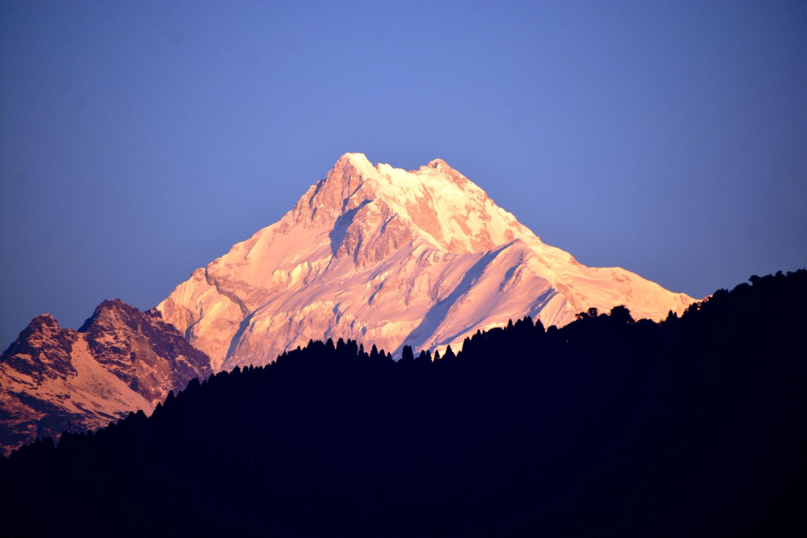Golden sunrise over Kanchenjunga peak in the Himalayan mountain range of Sikkim, India