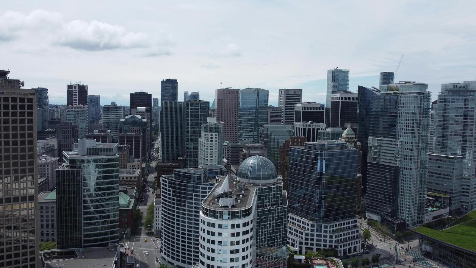 Aerial view of a dense downtown cluster of glass office towers