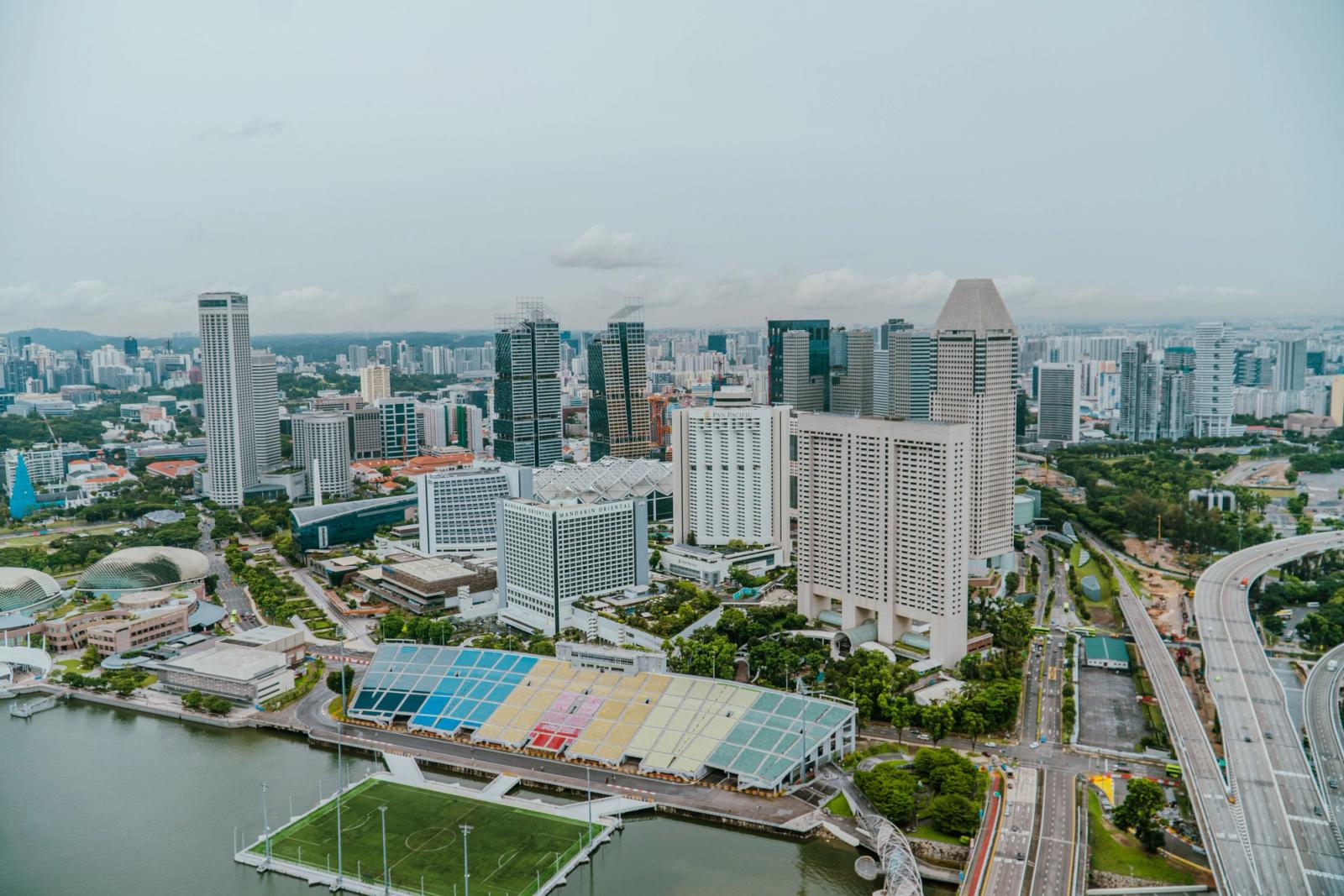 High-angle view of Singapore skyline with modern skyscrapers and urban development along Marina Bay
