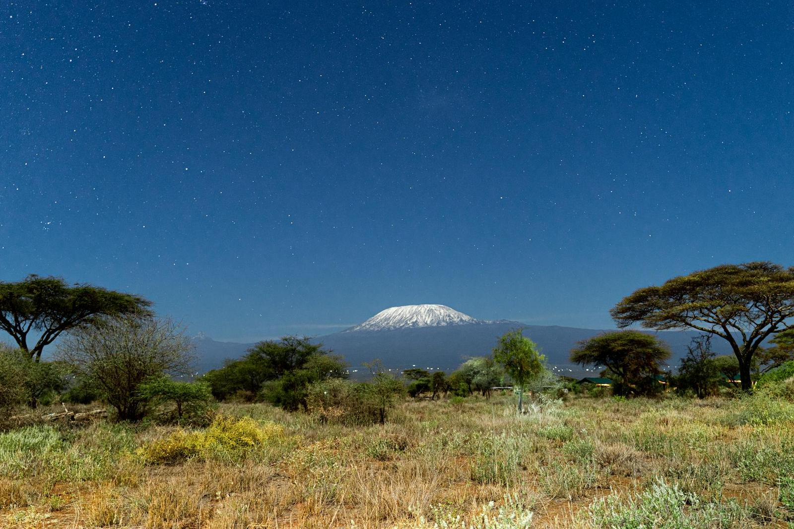 A breathtaking view of Mount Kilimanjaro framed by a clear starry night sky from Kajiado County, Kenya