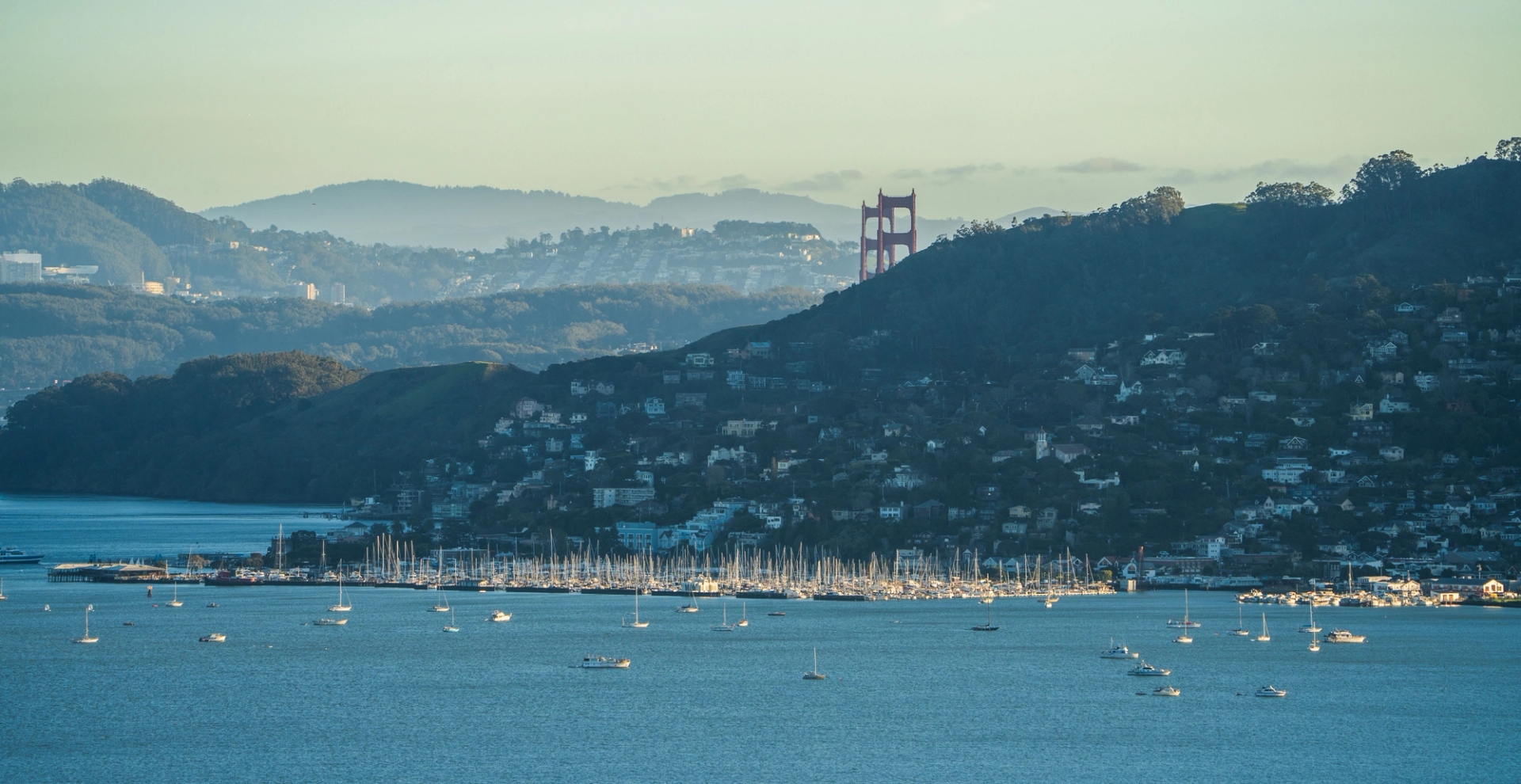 Scenic view of Golden Gate Bridge over San Francisco Bay with yachts in the foreground