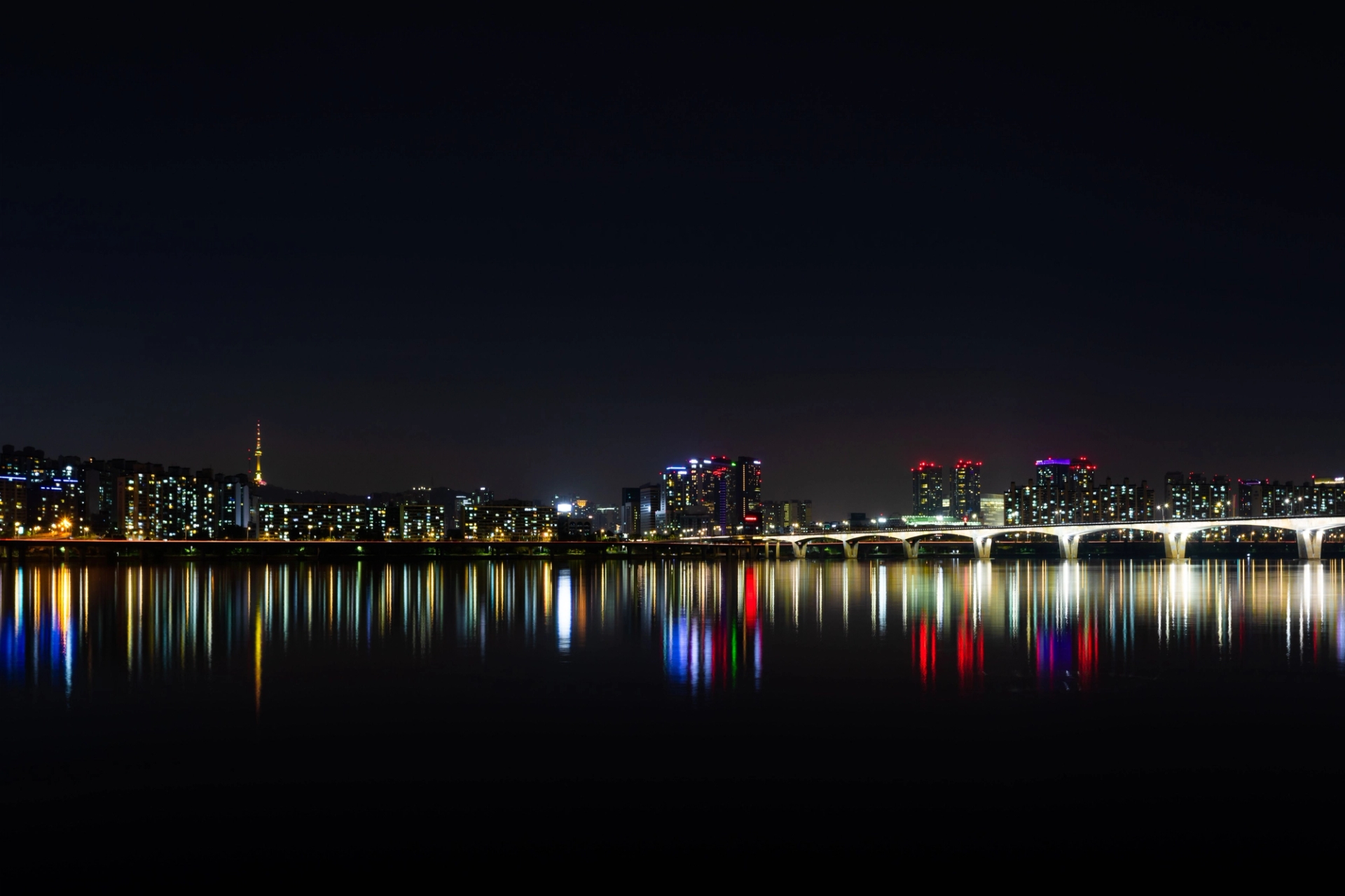 Stunning night view of Seoul's illuminated skyline reflected over the Han River