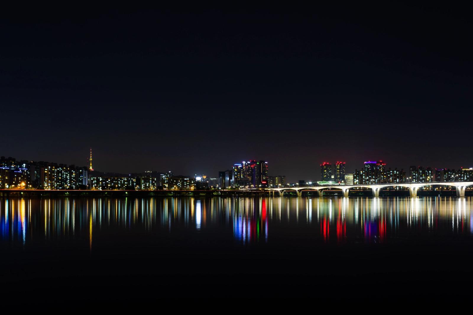 Stunning night view of Seoul's illuminated skyline reflected over the Han River