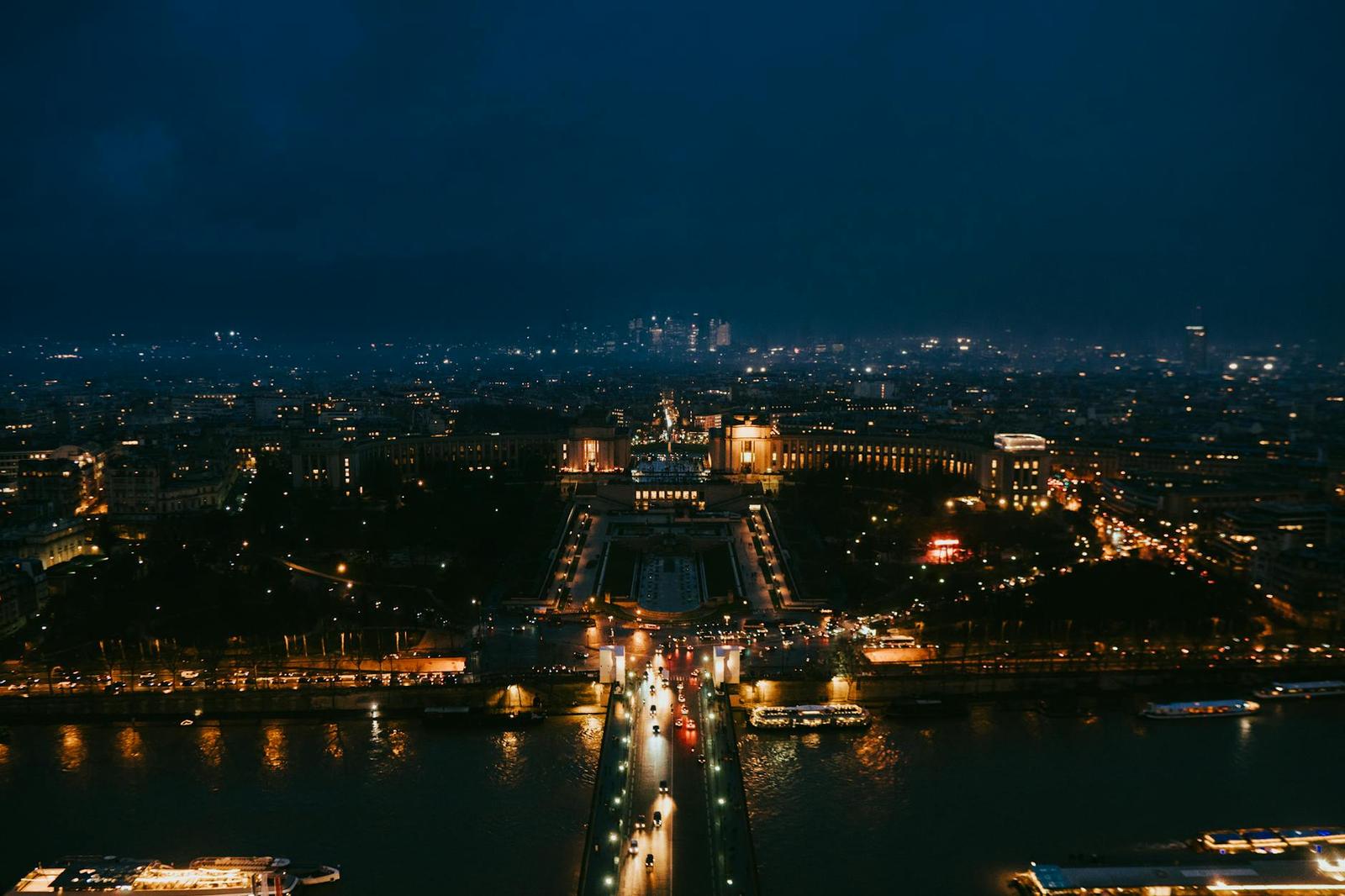 Stunning nighttime aerial cityscape of Paris highlighting iconic landmarks