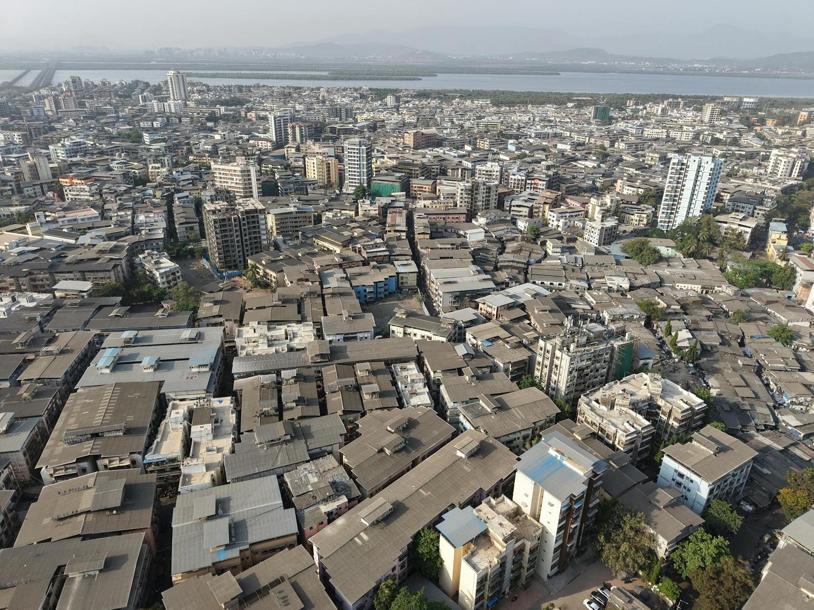 Aerial view of a dense urban neighbourhood beside a wide river