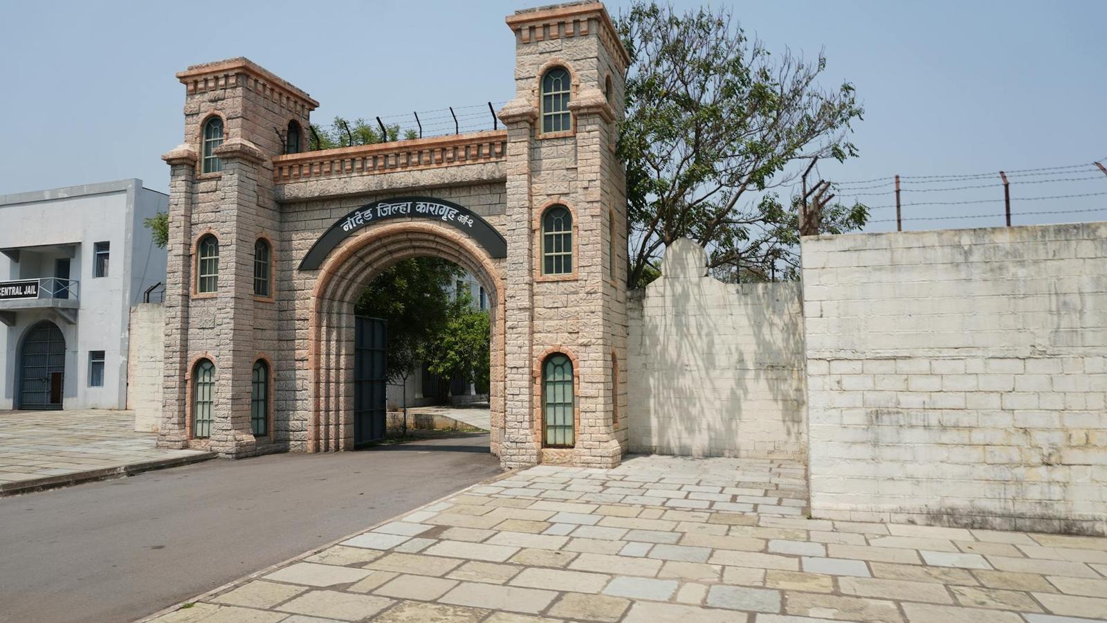 Stone entrance of a historic jail with arches and towers in Nanded, India