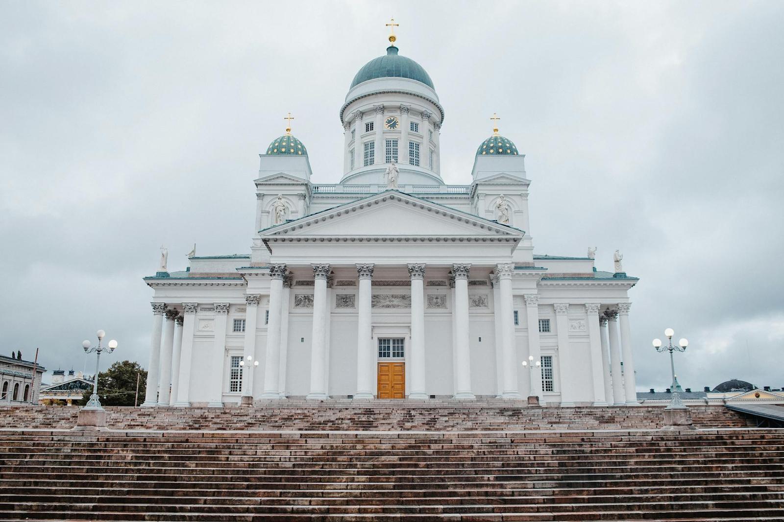A frontal view of the iconic Helsinki Cathedral featuring neoclassical architecture under a cloudy sky