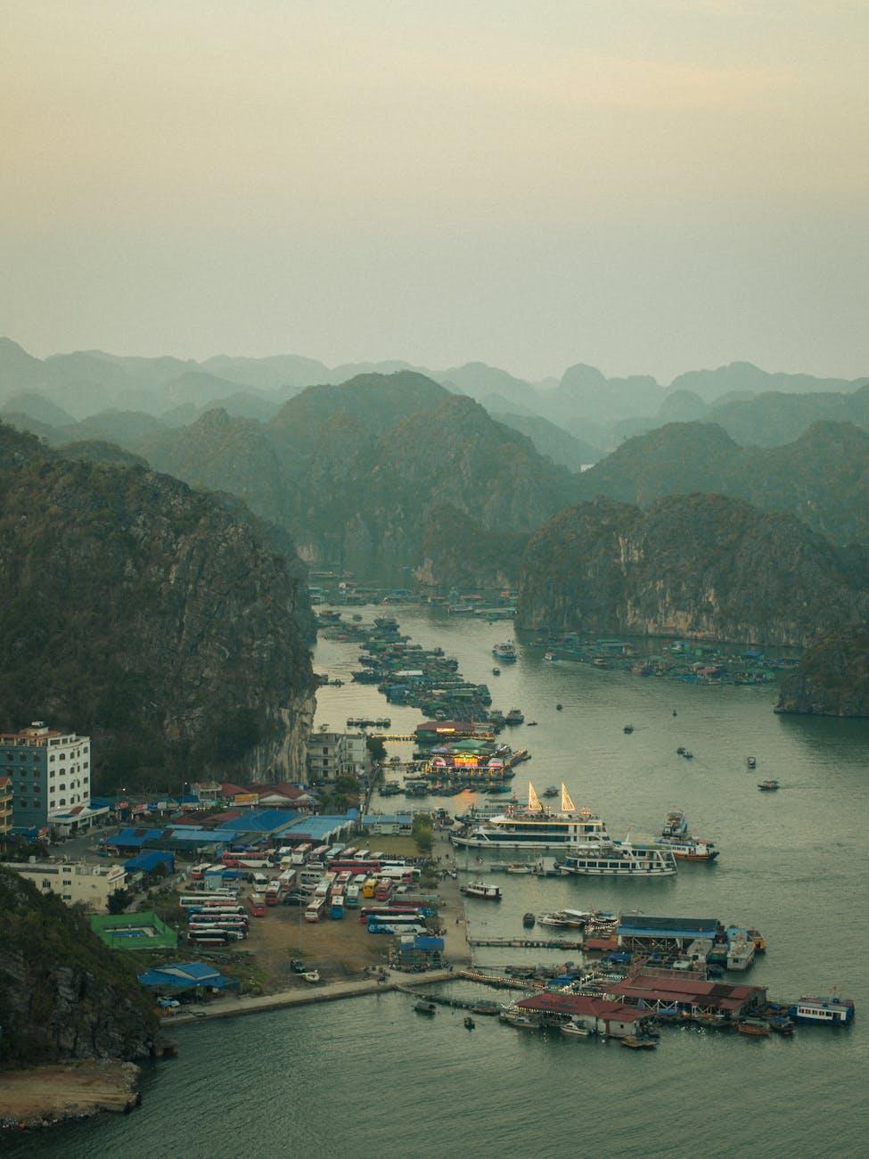 Aerial photo of Lan Ha Bay with boats, misty islands, and coastal structures