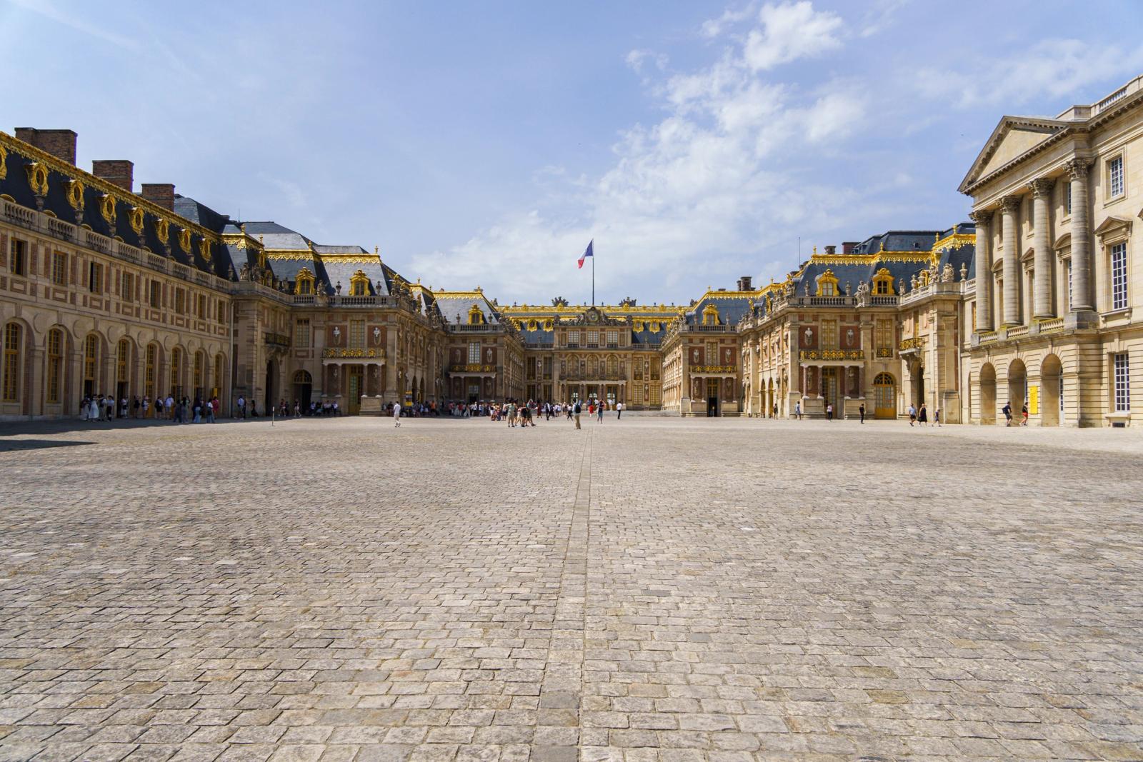 Explore the stunning architecture of the Palace of Versailles on a sunny day in Paris, France