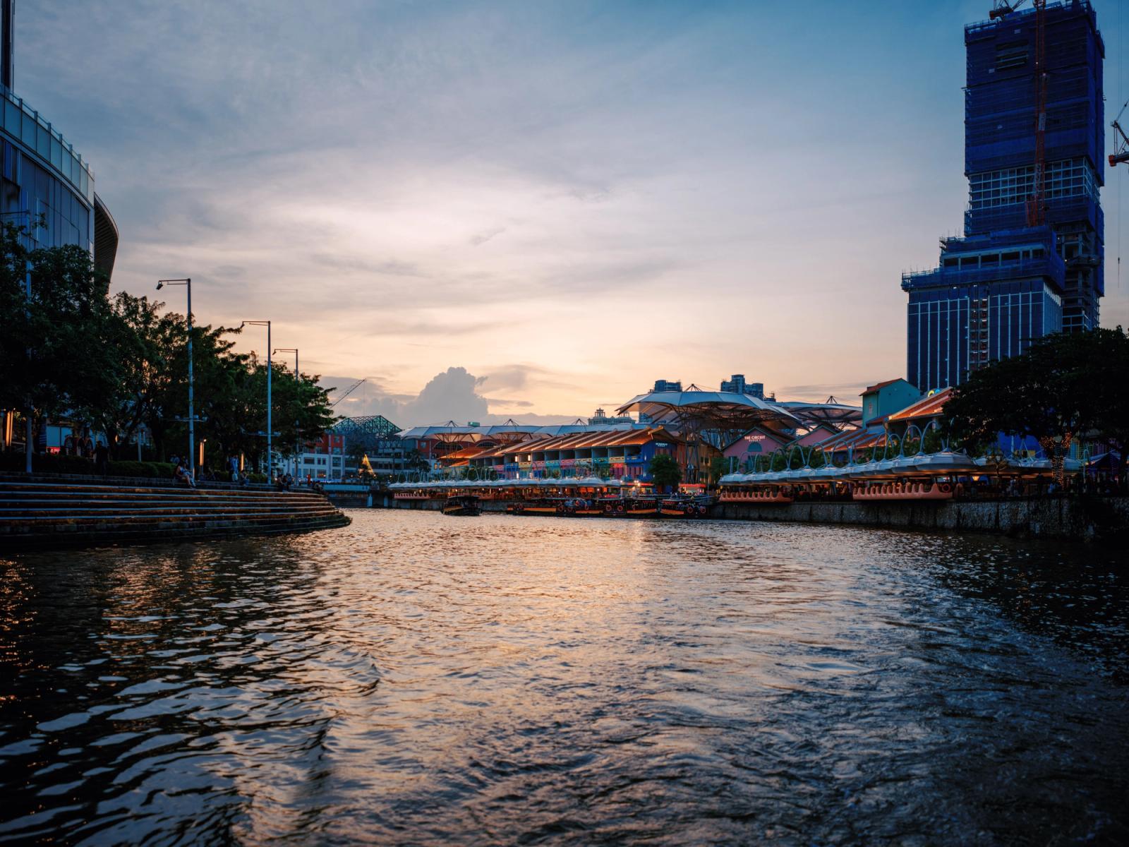 Serene view of Singapore River at sunset with skyline and riverside buildings
