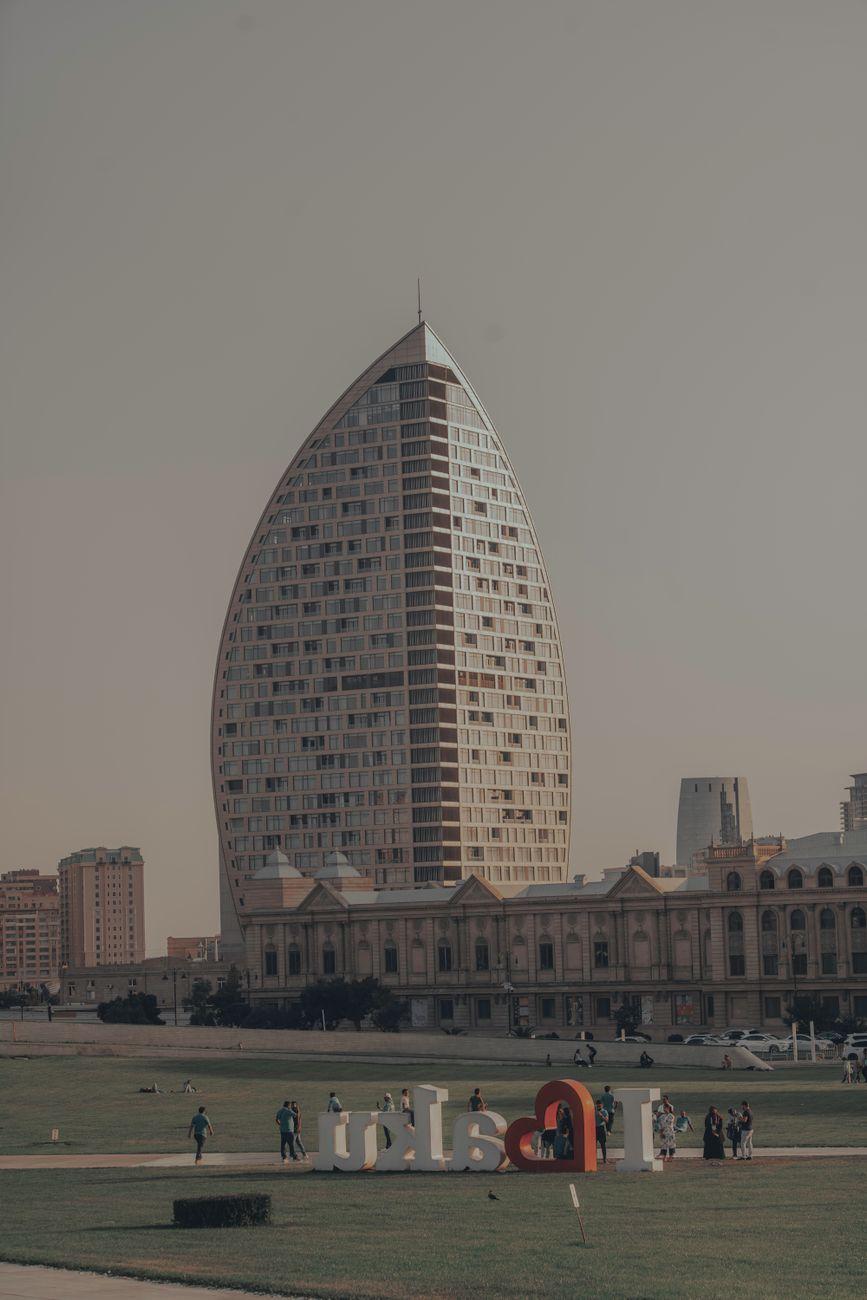 View of an iconic modern tower surrounded by a park in Baku, Azerbaijan
