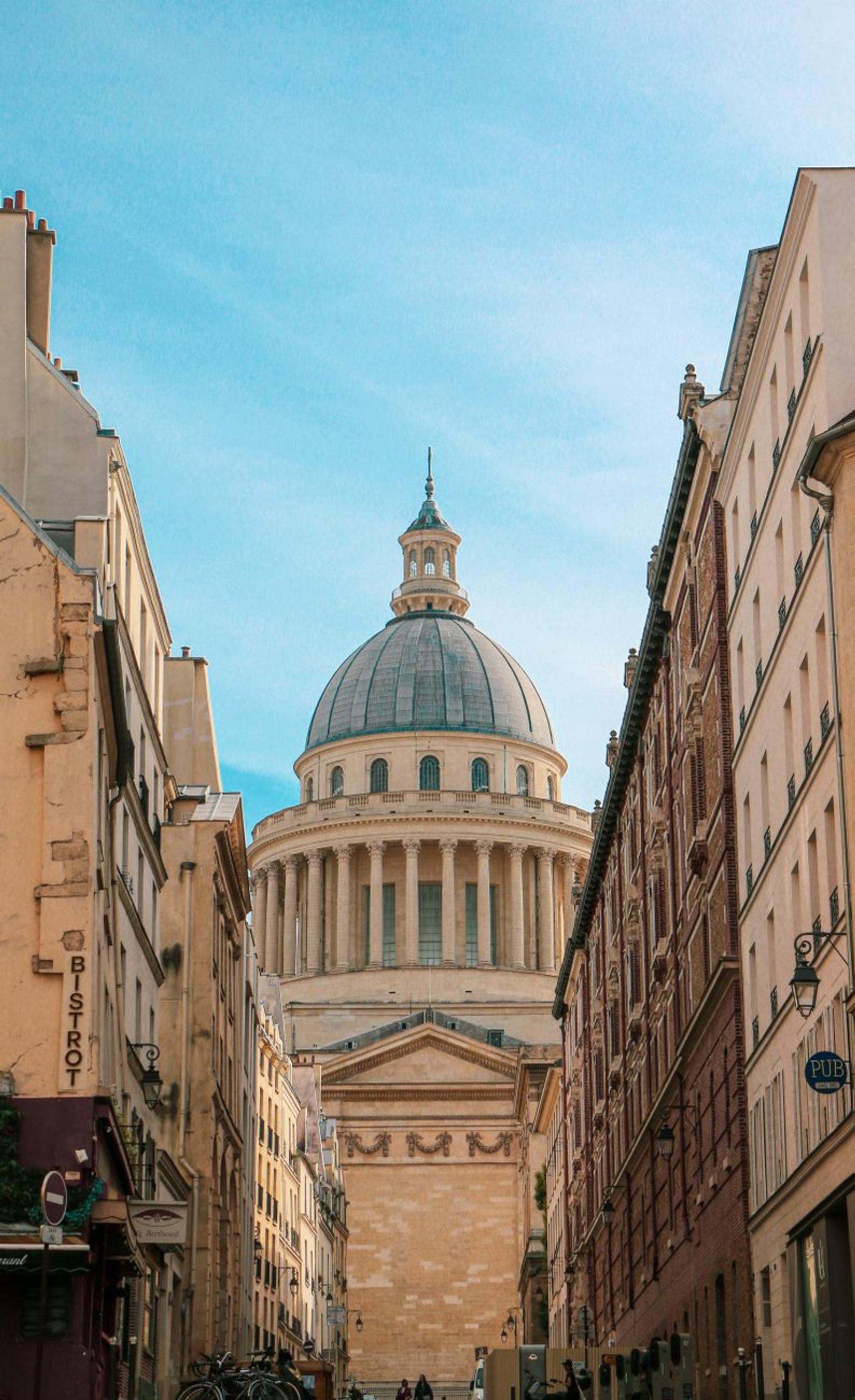 Elevated view of the iconic Panthéon dome framed by historic Parisian architecture