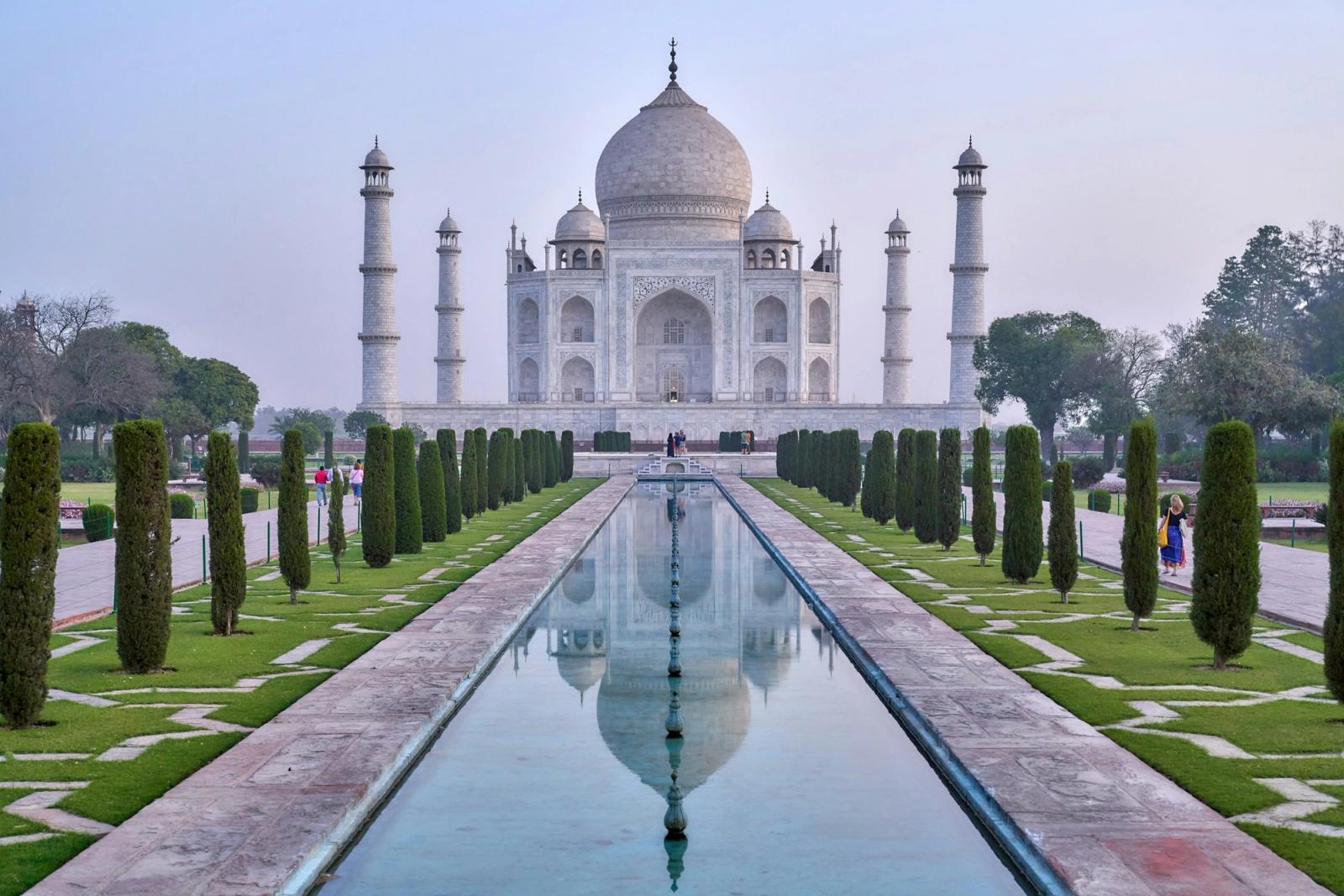 The Taj Mahal mirrored in still water at dawn