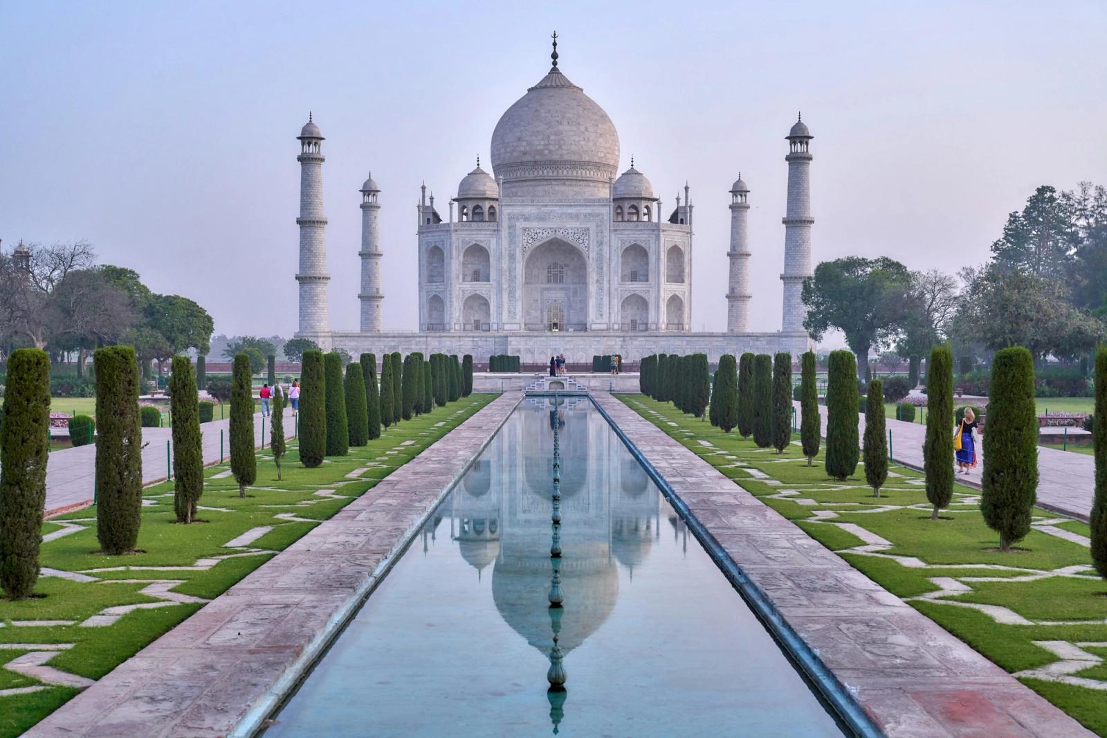 The Taj Mahal mirrored in still water at dawn