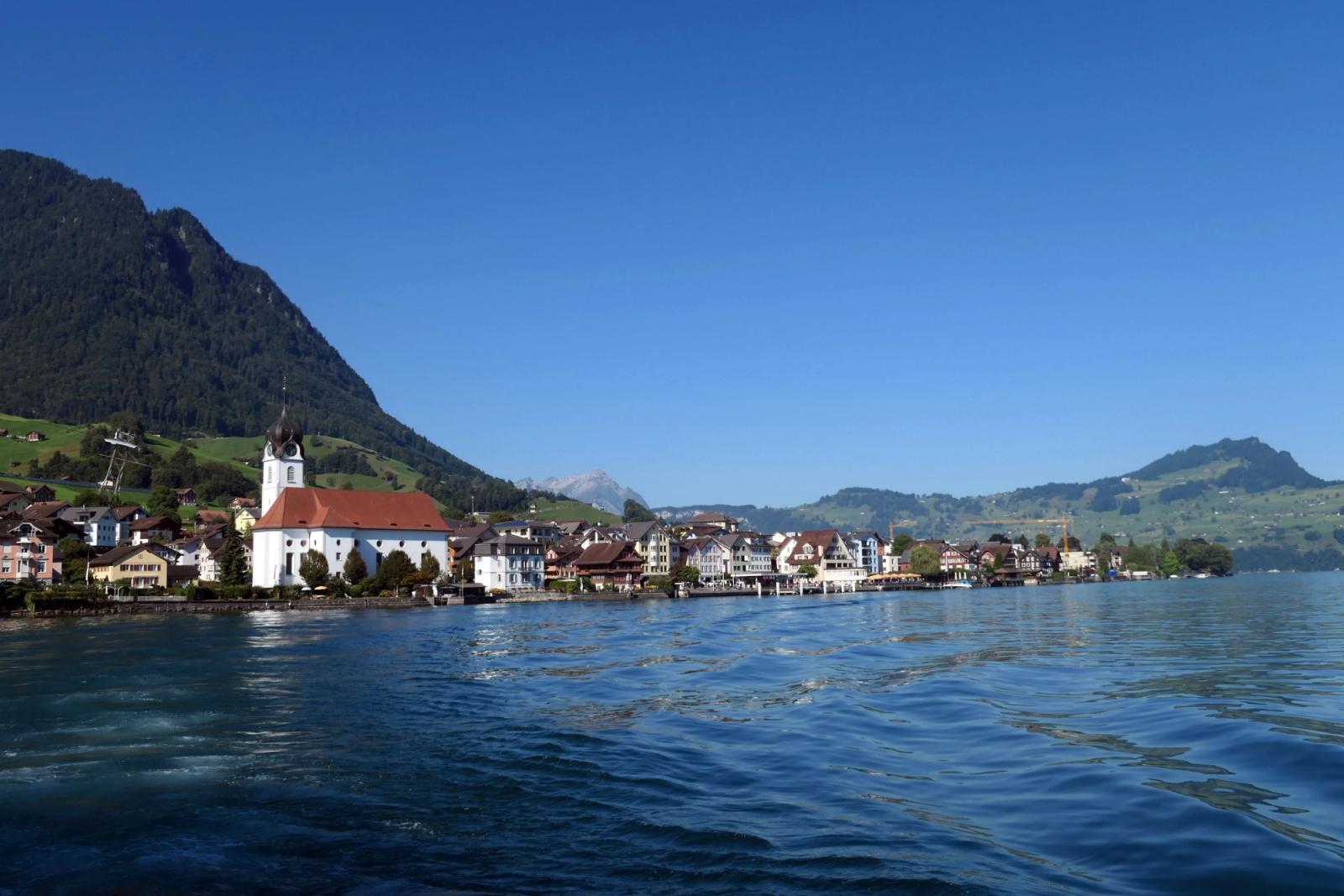 Picturesque view of Beckenried by Lake Lucerne, showcasing Swiss architecture against mountain backdrop