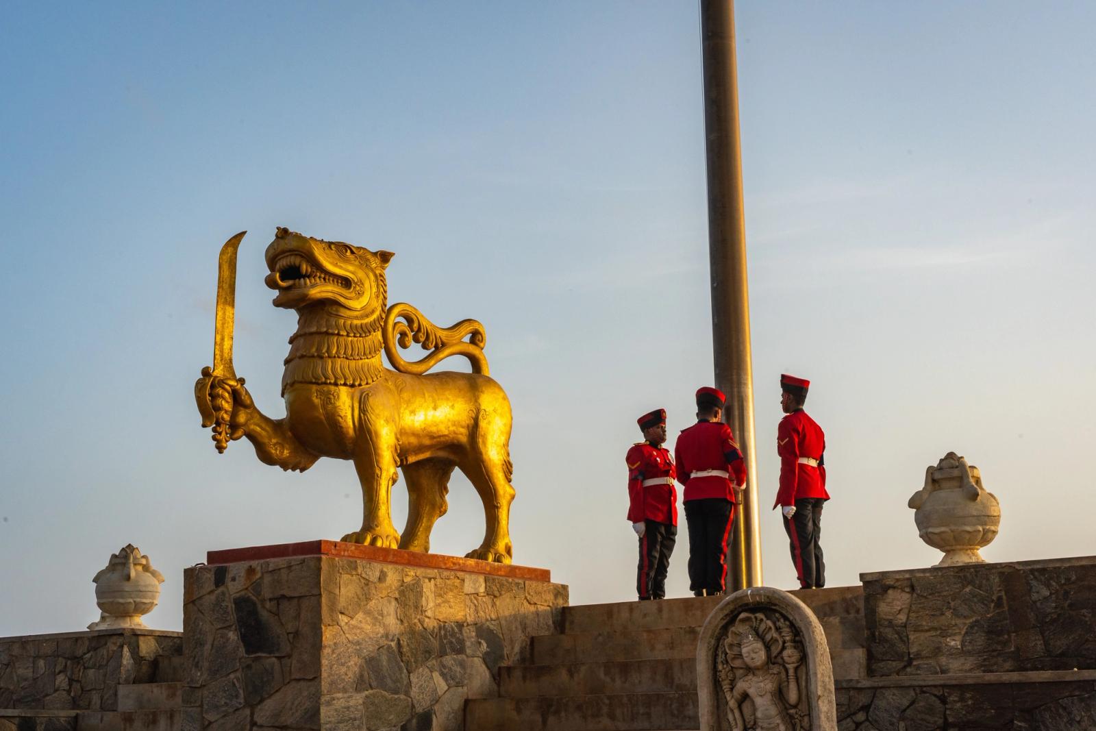 Golden lion statue and guards at Independence Memorial Square, Colombo, Sri Lanka