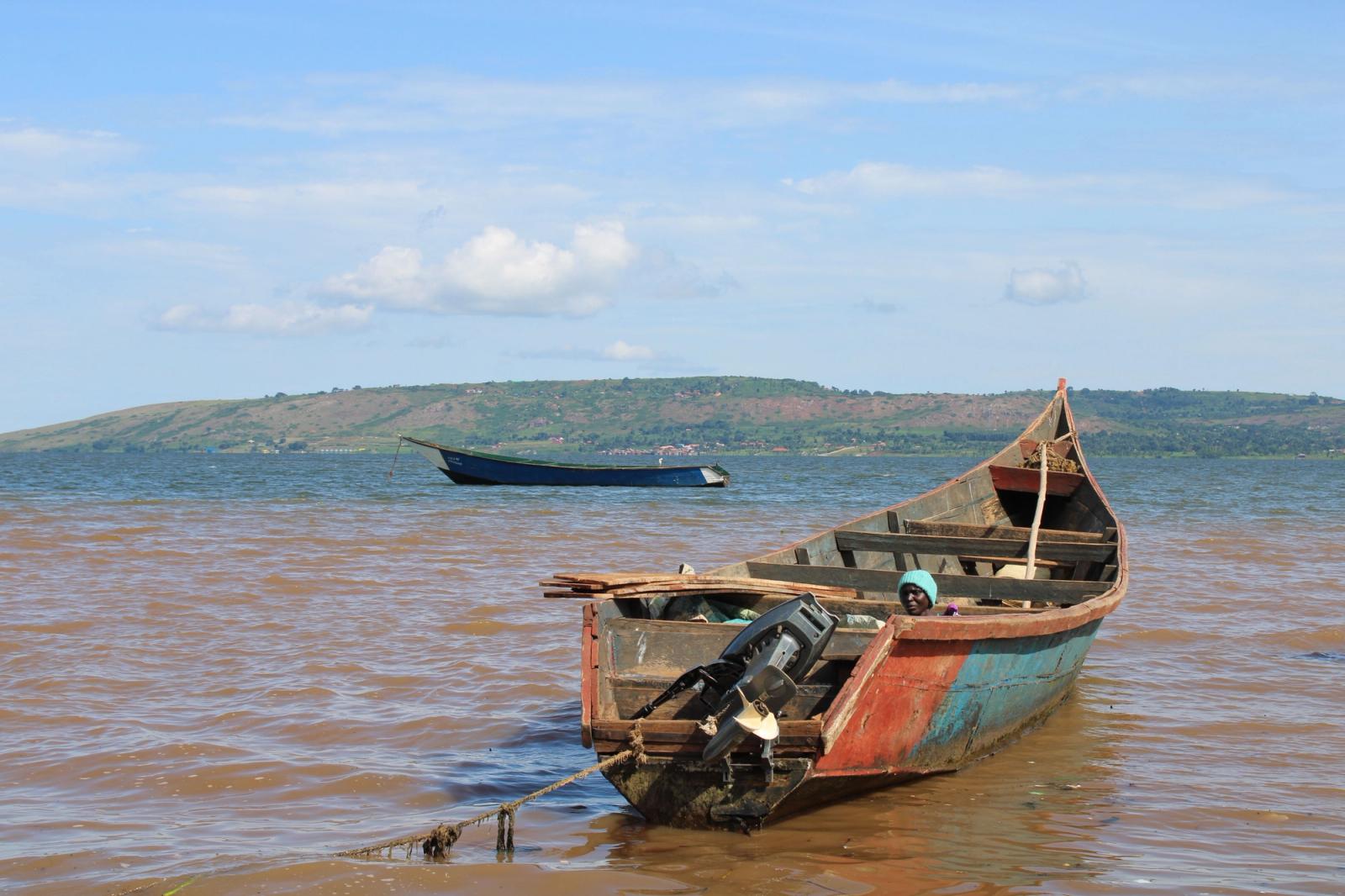 Rustic fishing boat moored on Lake Victoria in Jinja, Uganda, under a clear sky