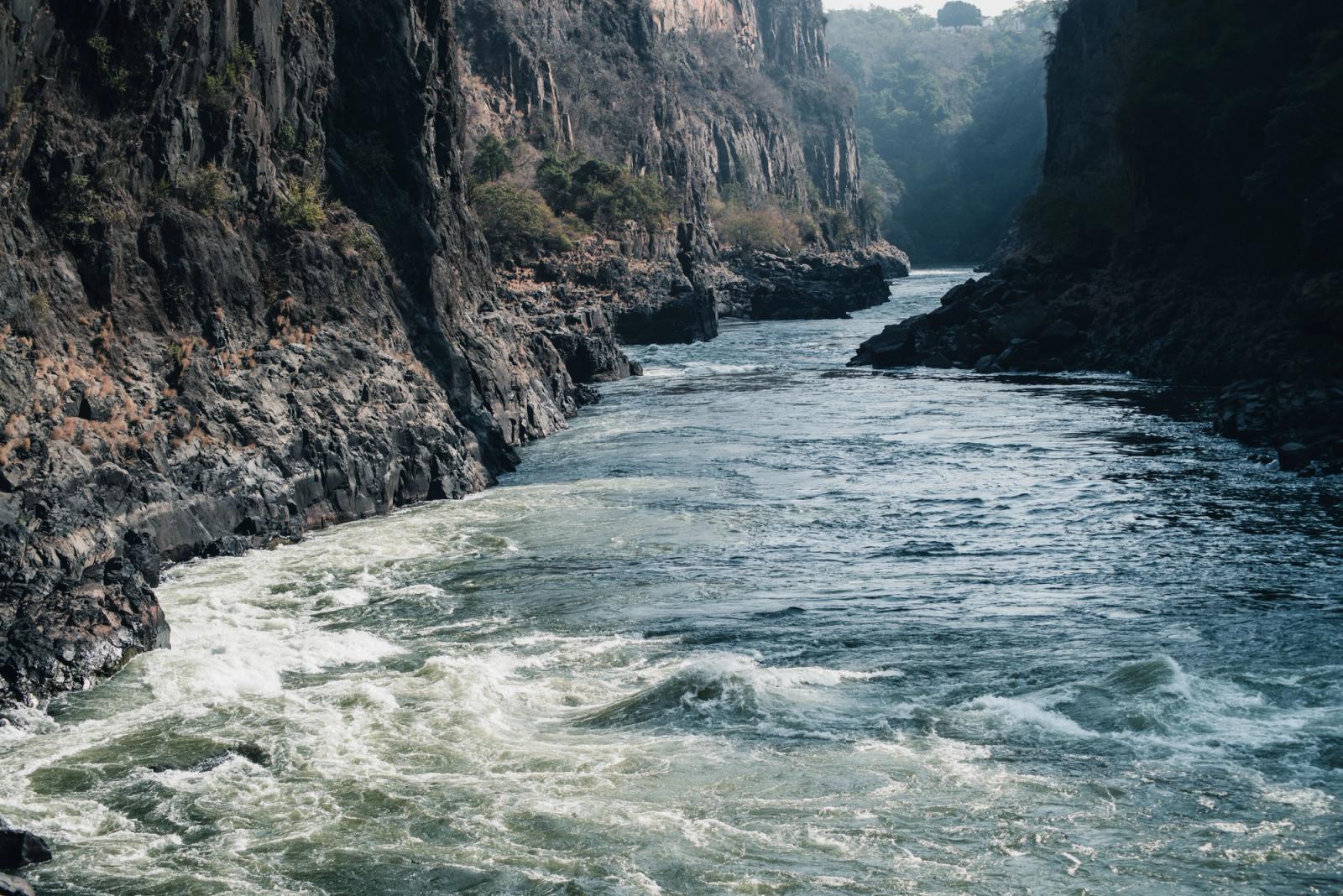Dramatic view of a river cutting through a rocky gorge, showcasing nature's raw power and beauty