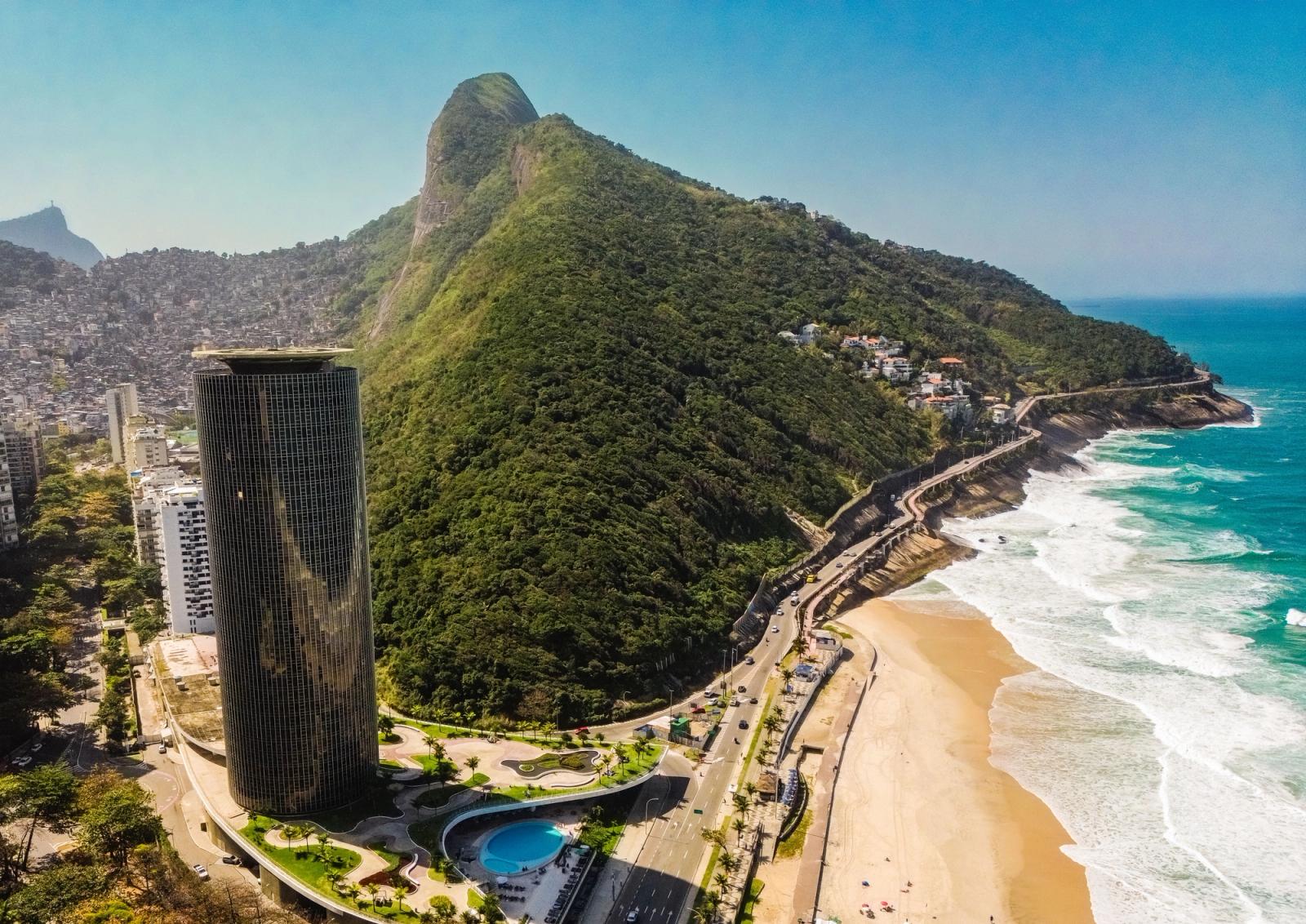Scenic aerial view of Rio de Janeiro's coastline with lush mountains and a vibrant beach