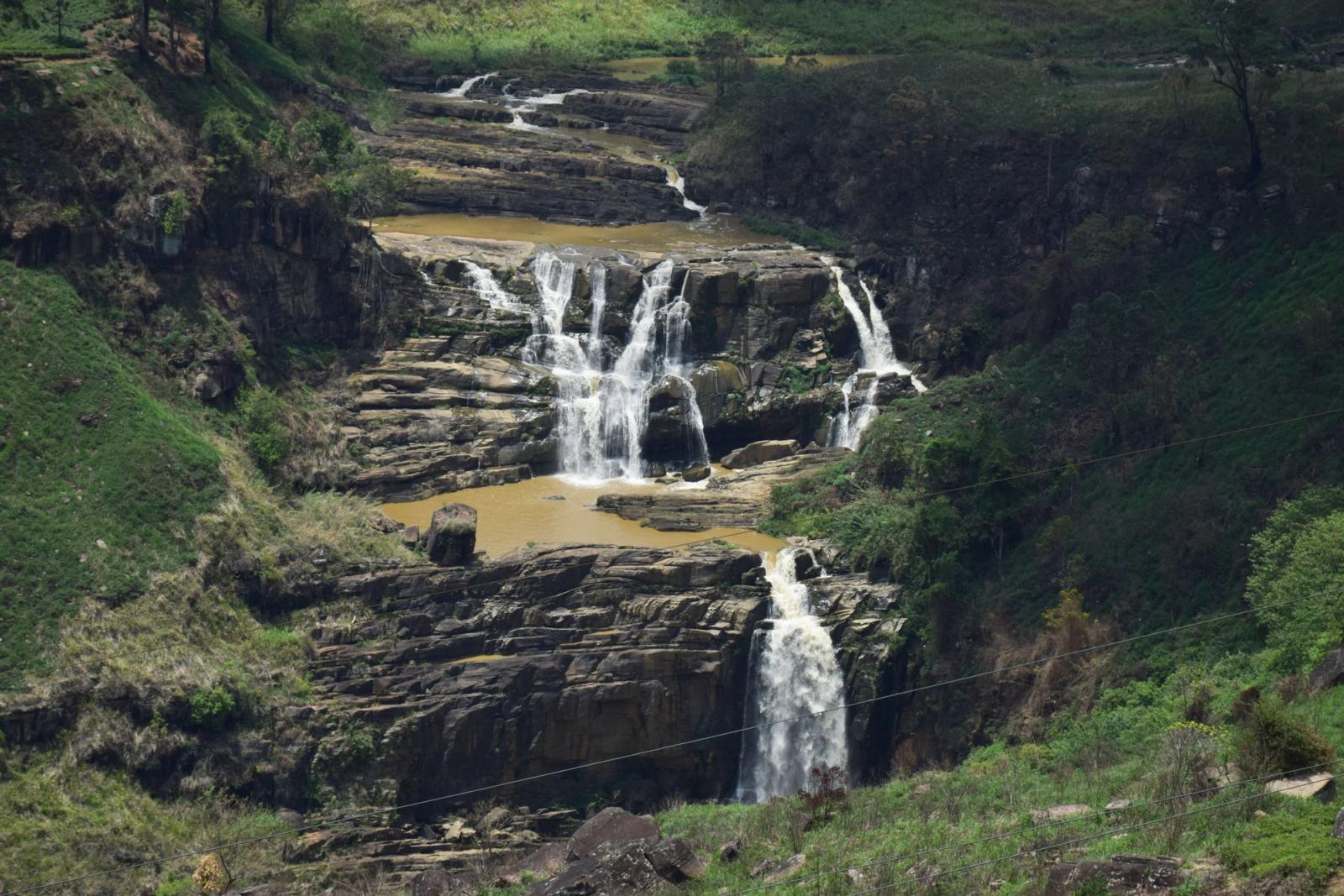 A picturesque waterfall cascading through rocky terrain in Nuwara Eliya, Sri Lanka