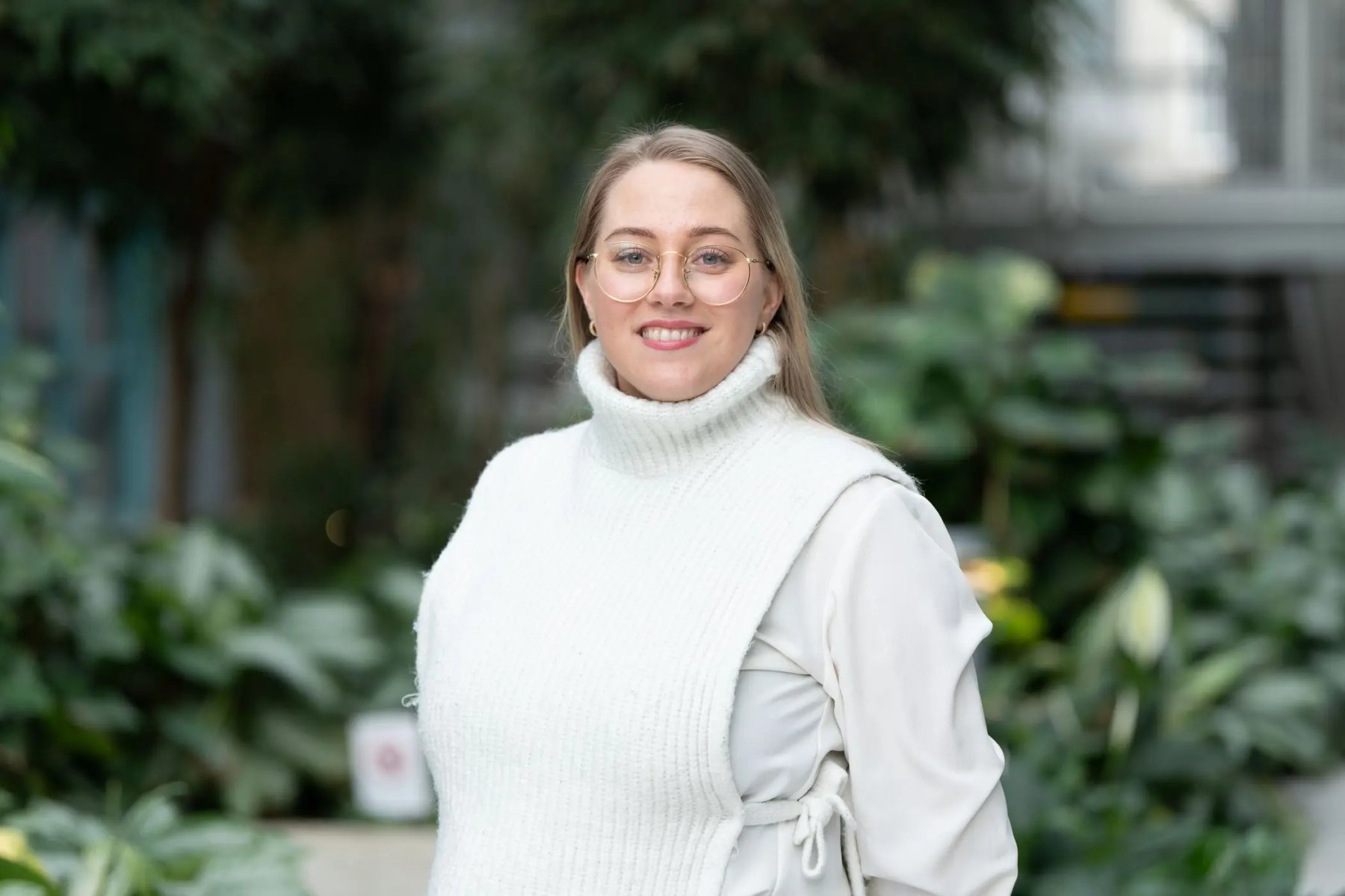 Monja Lien Jakobsen (Chair of the Board), student representative, smiling at the camera in a green outdoor setting.