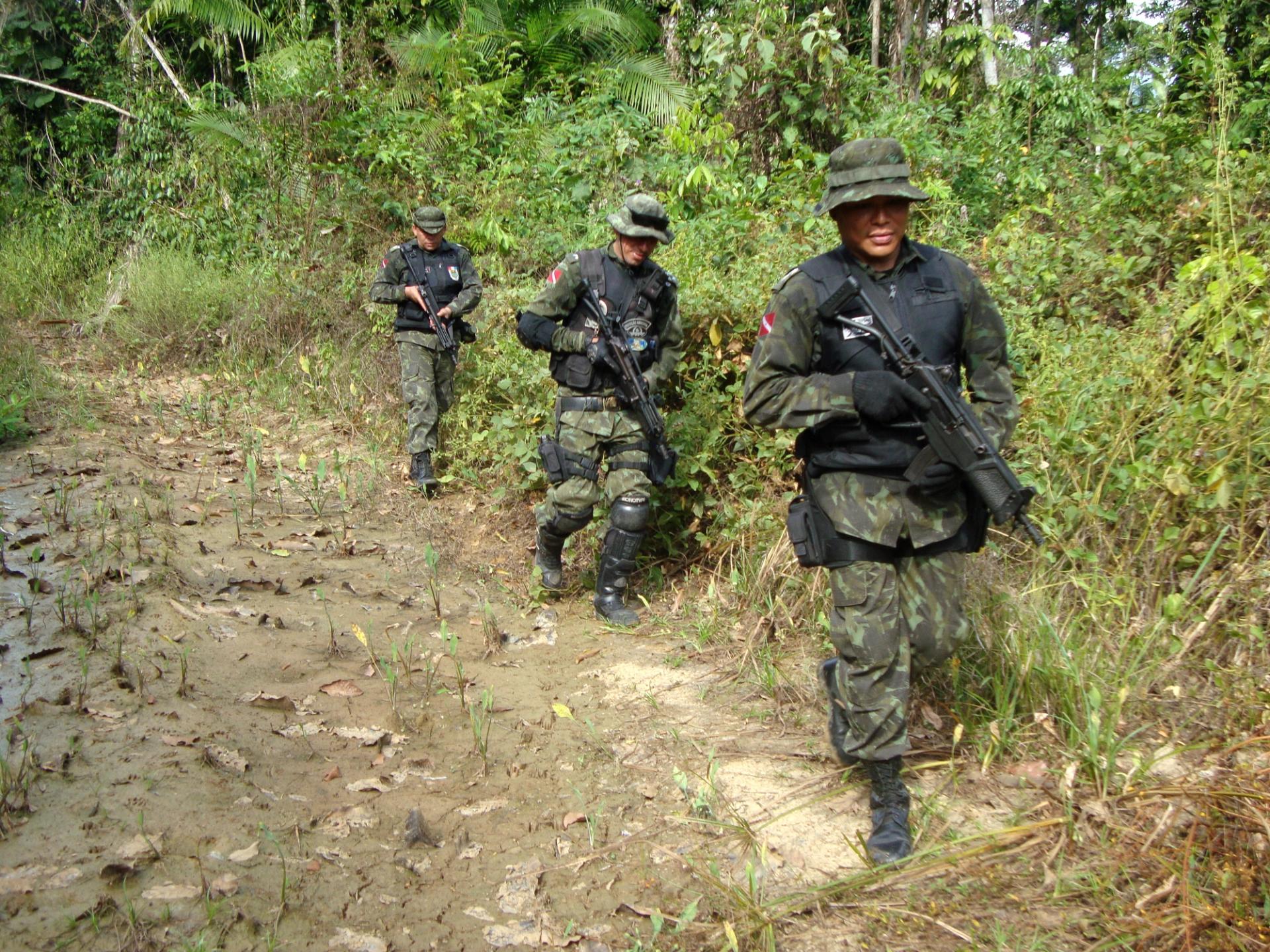 Photo of three armed police on patrol, walking towards the camera