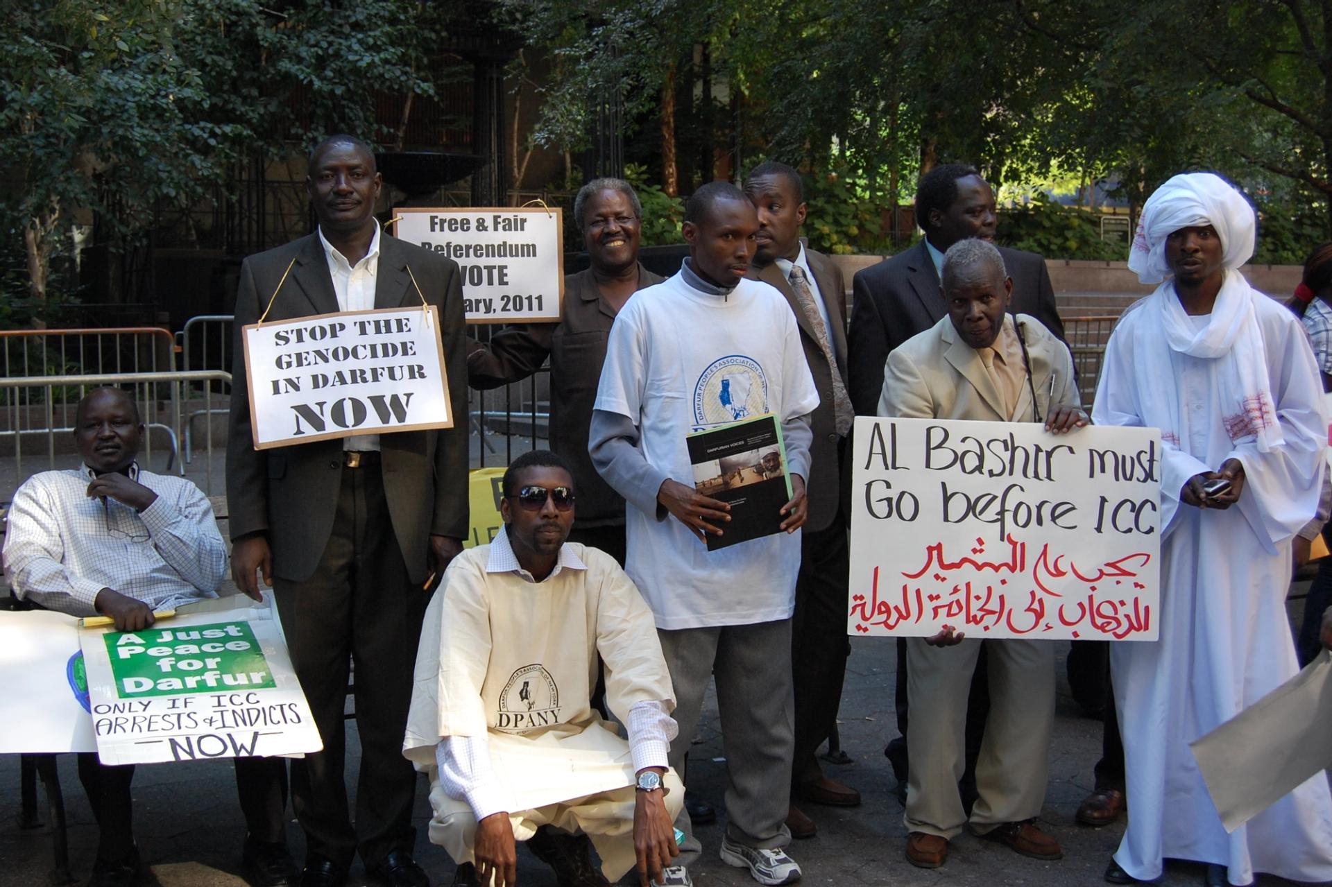 Protesters with posters calling for Al Bashir to go 