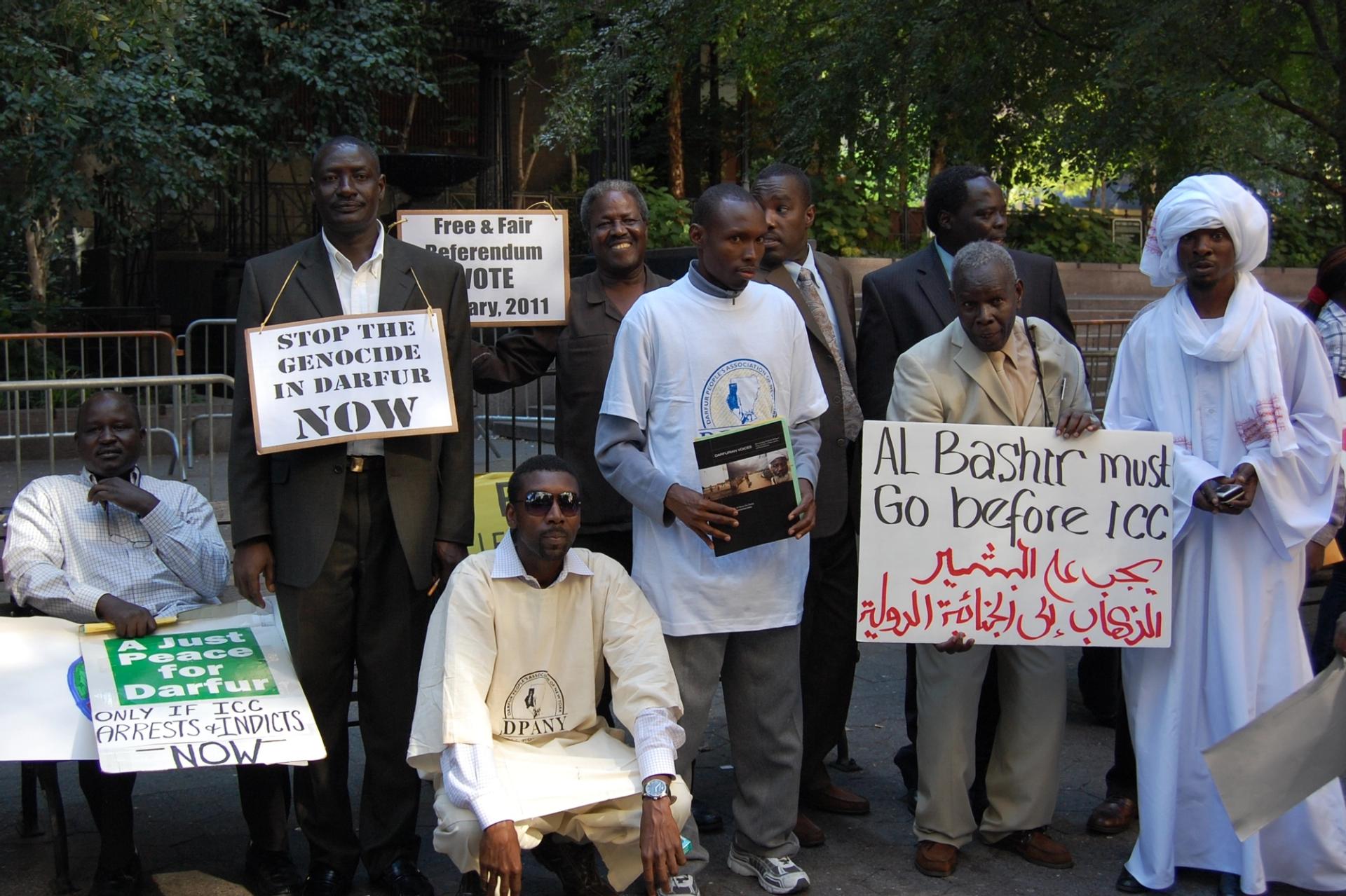 Protesters with posters calling for Al Bashir to go