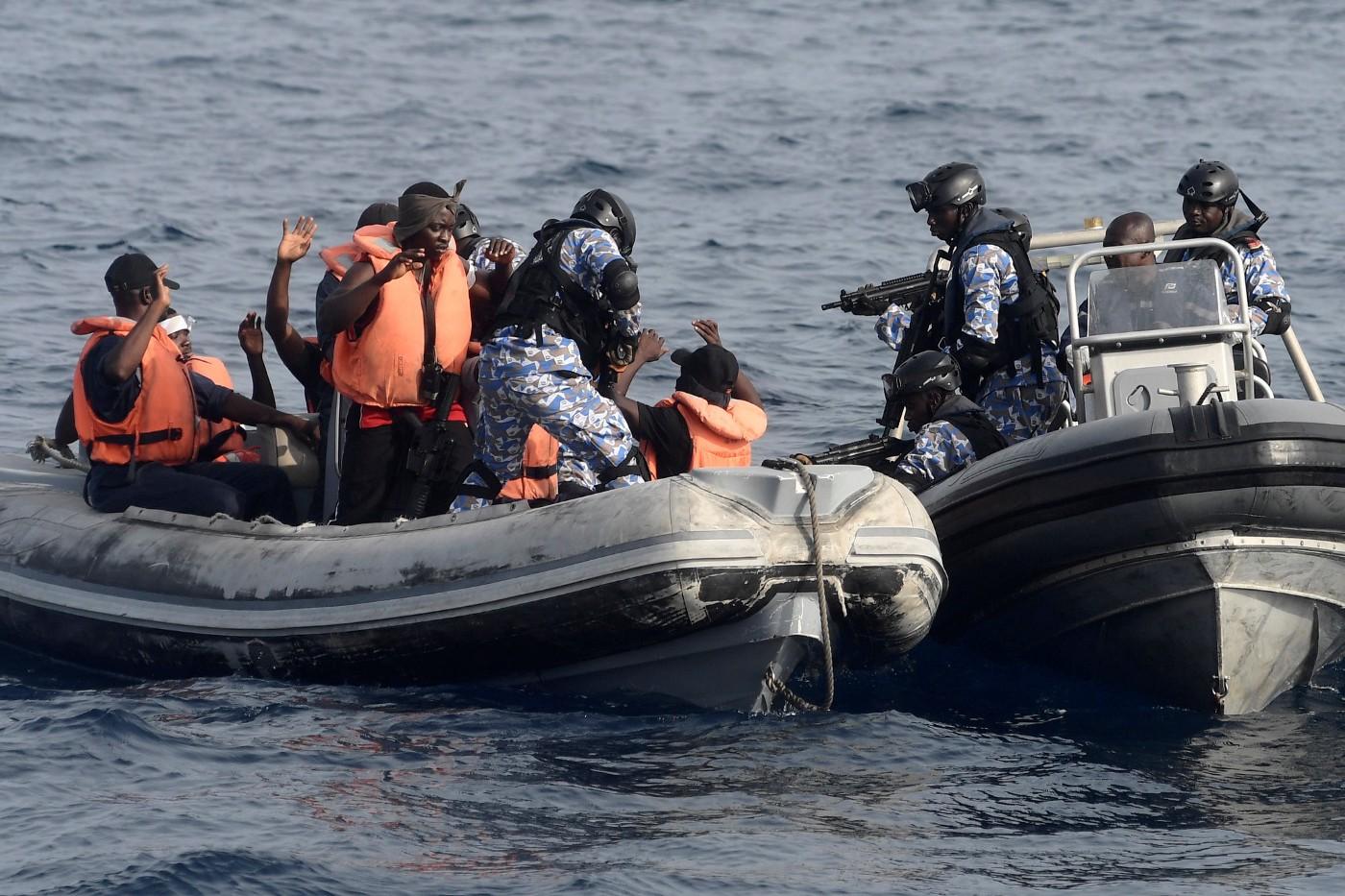 Patrol boat stopping a boat with people in life-vests