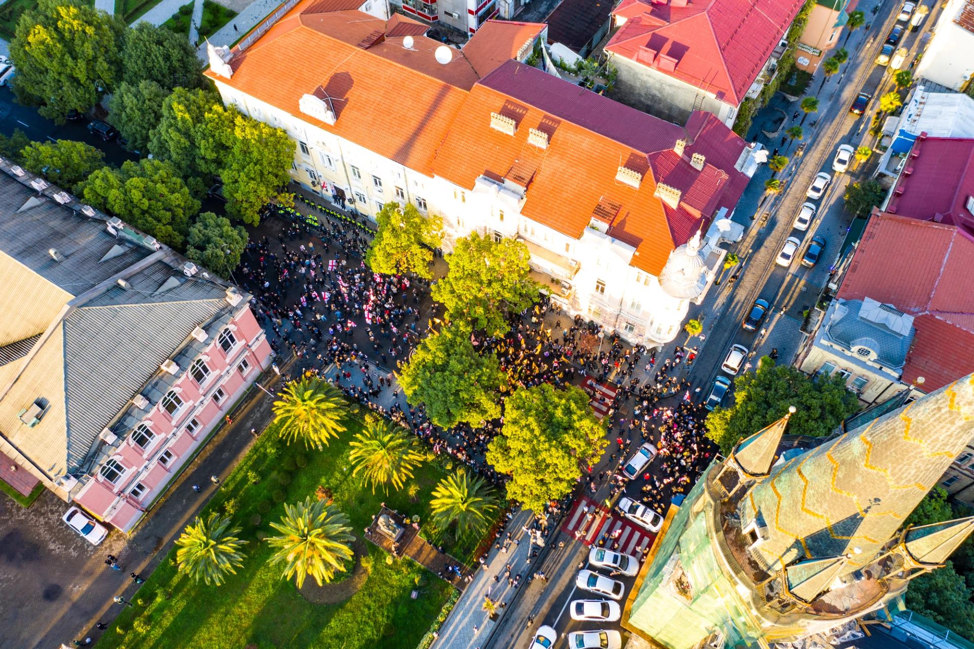 Photo of a protest march taken from a drone above a city street.