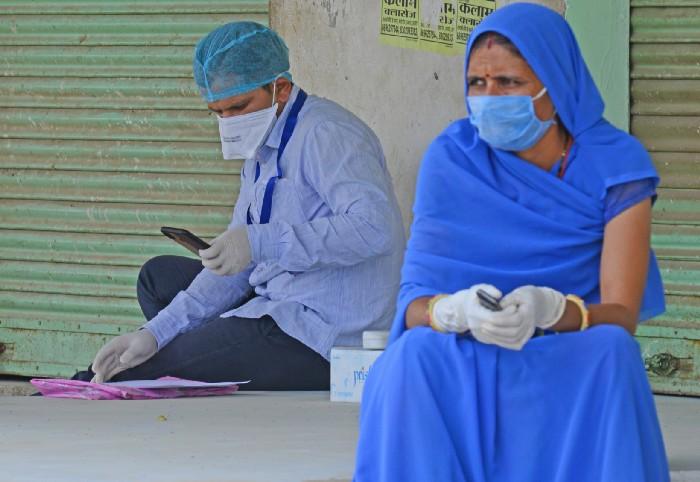  Medical staff wearing protective face mask at Roopnagar village during first day of curfew imposed in 28 village after COVID-19 case in Beawar.