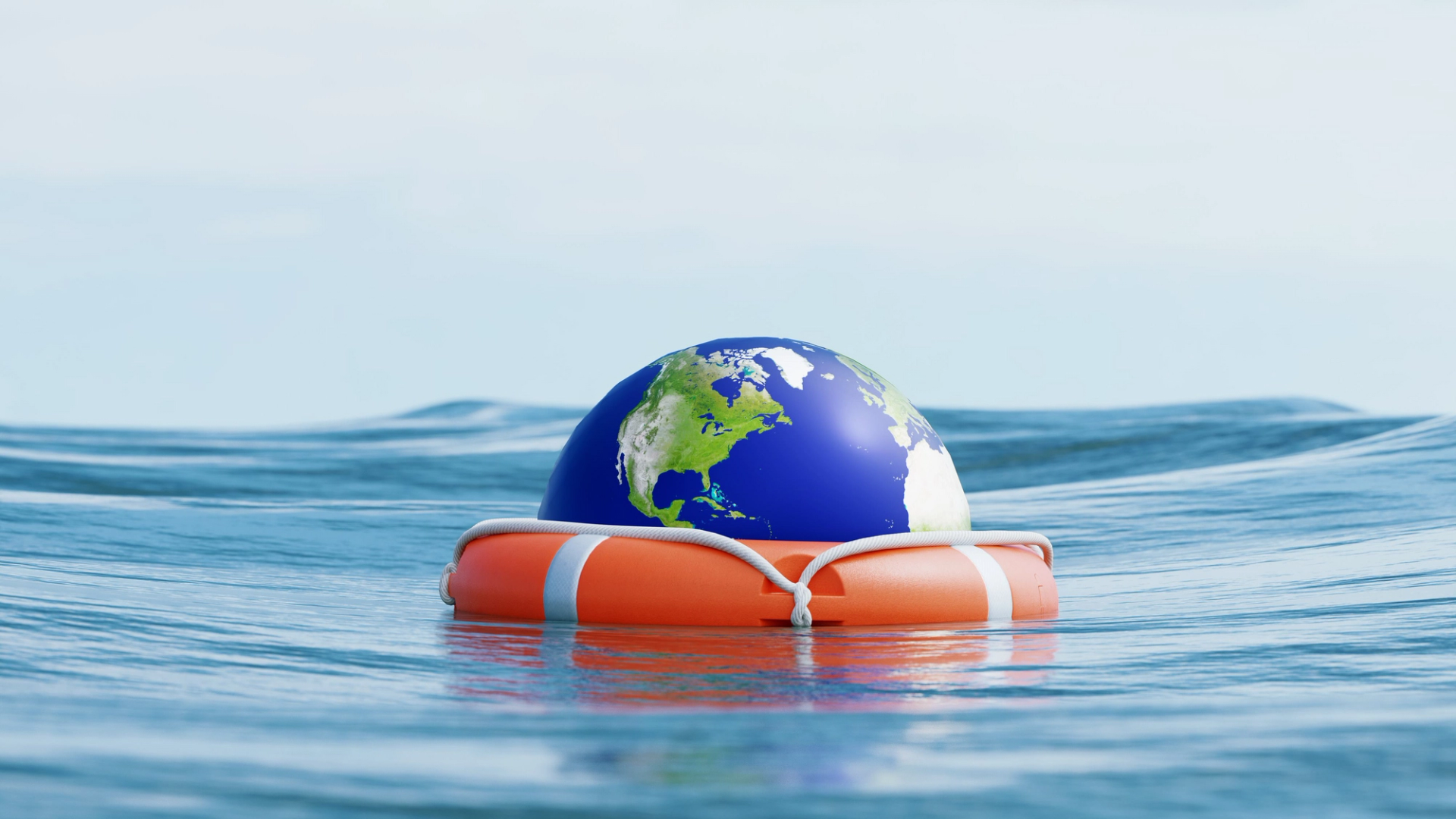 A toy earth inside a lifebuoy floats on the water.