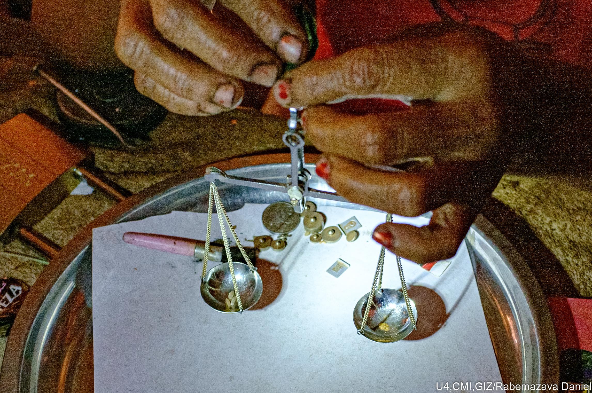 Weighing out gold with a scale