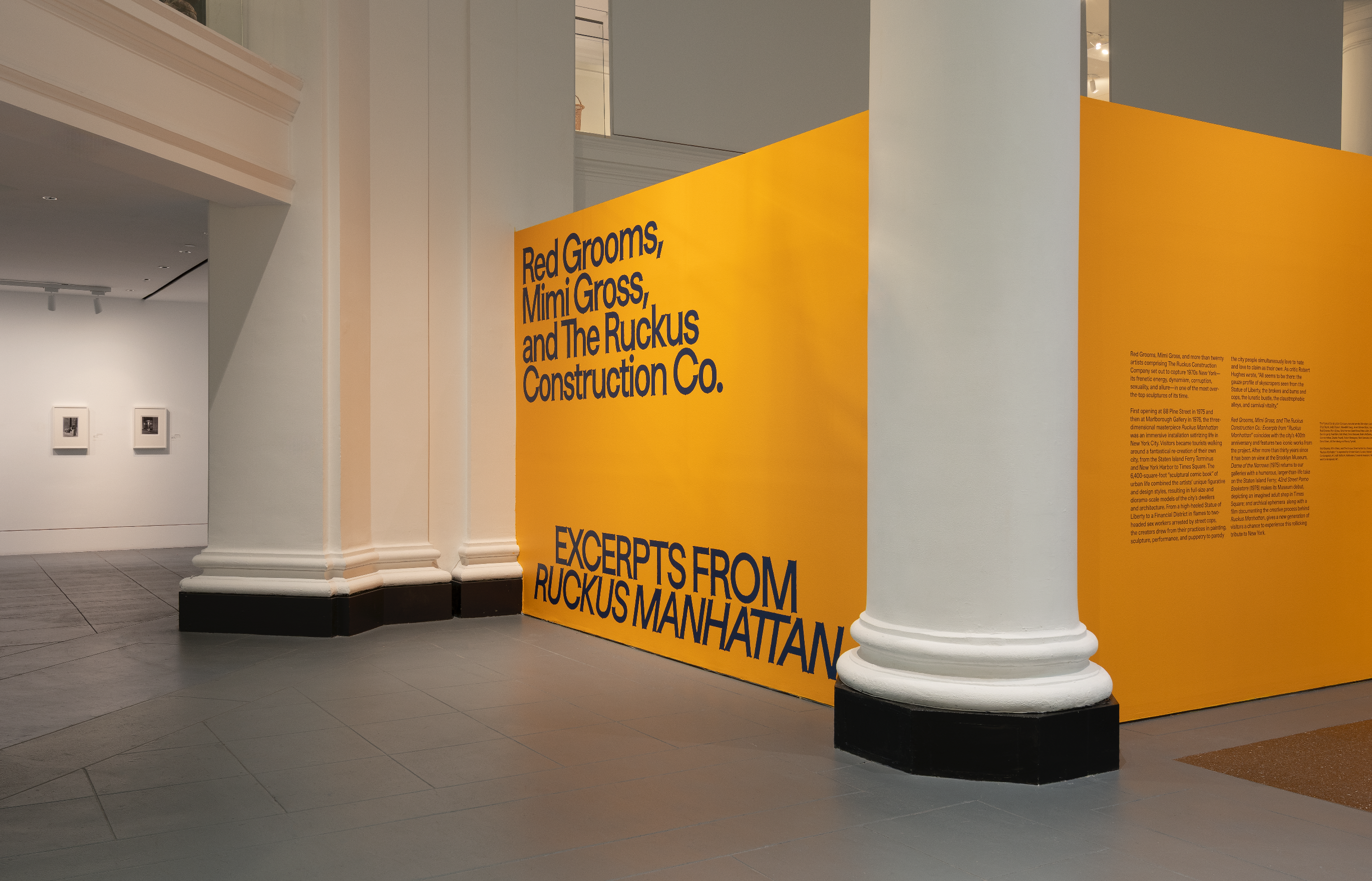 Yellow wall with blue text: "Red Grooms, Mimi Gross, and The Ruckus Construction Co. EXCERPTS FROM RUCKUS MANHATTAN"