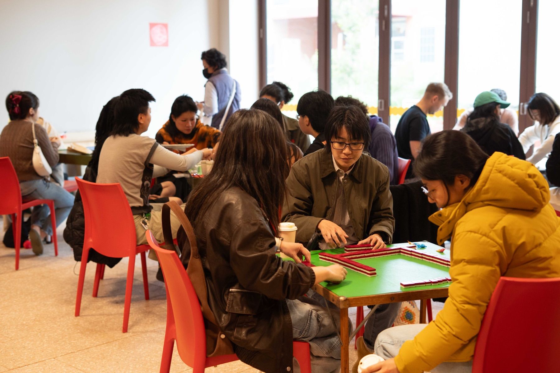 People playing games around tables at a community gathering