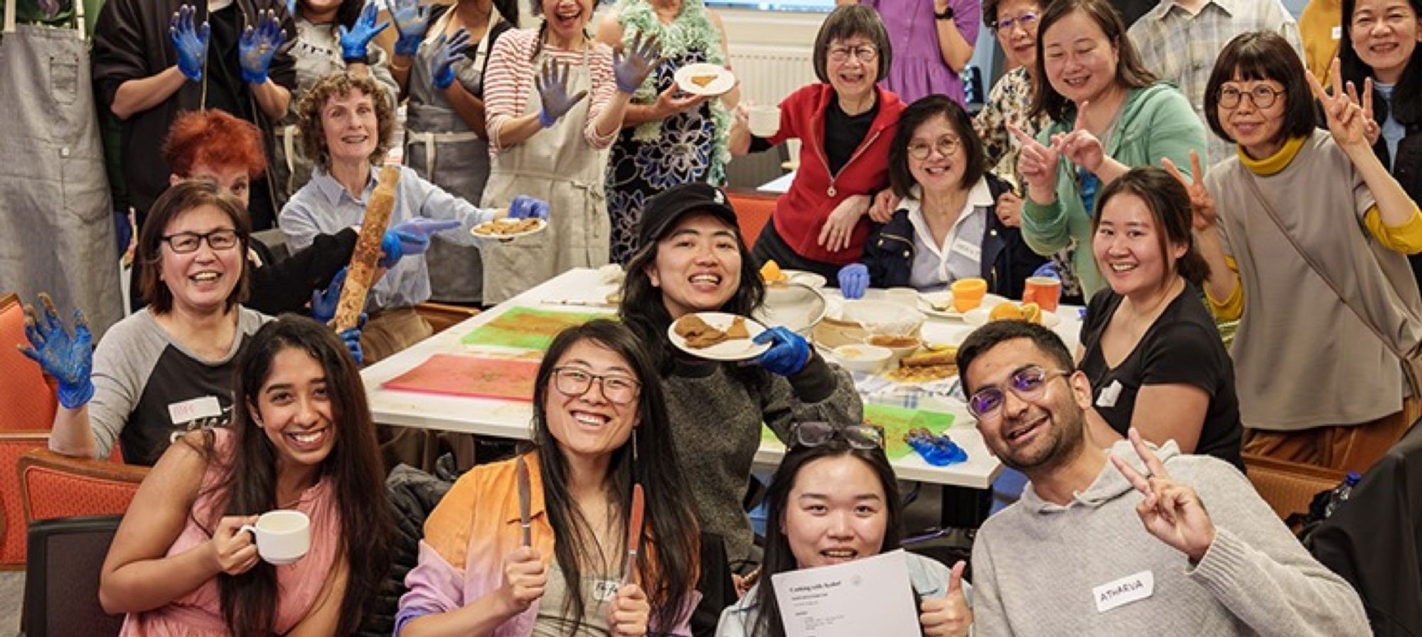 People sharing food at a long community table