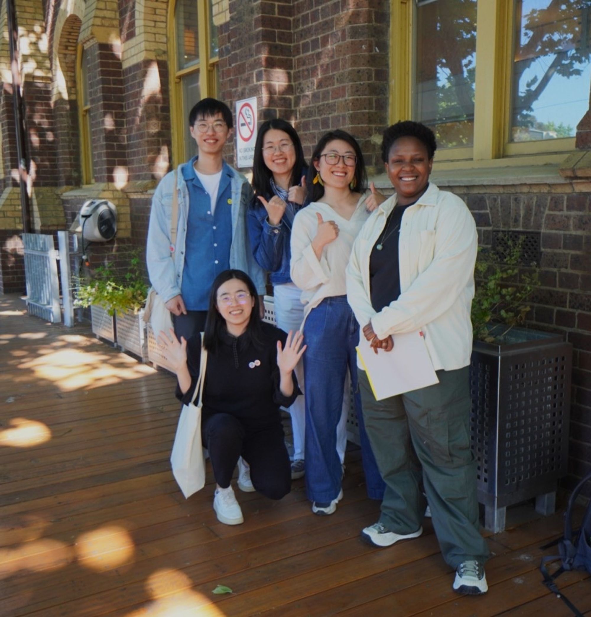 A small group smiling together outdoors