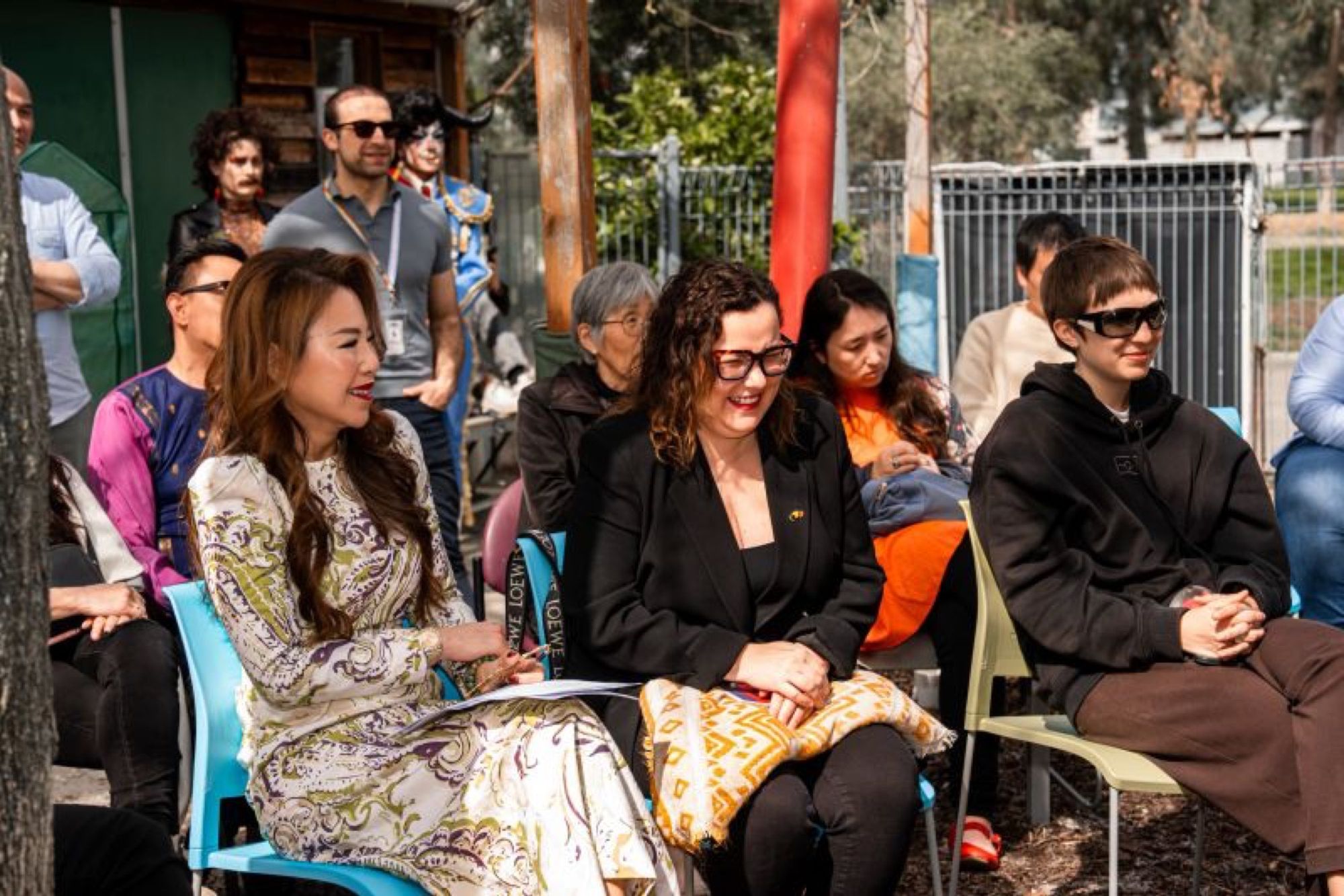 Friends seated together at an outdoor festival