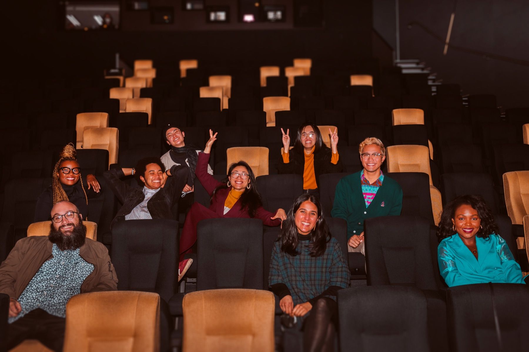 A group waving from cinema seats after a screening
