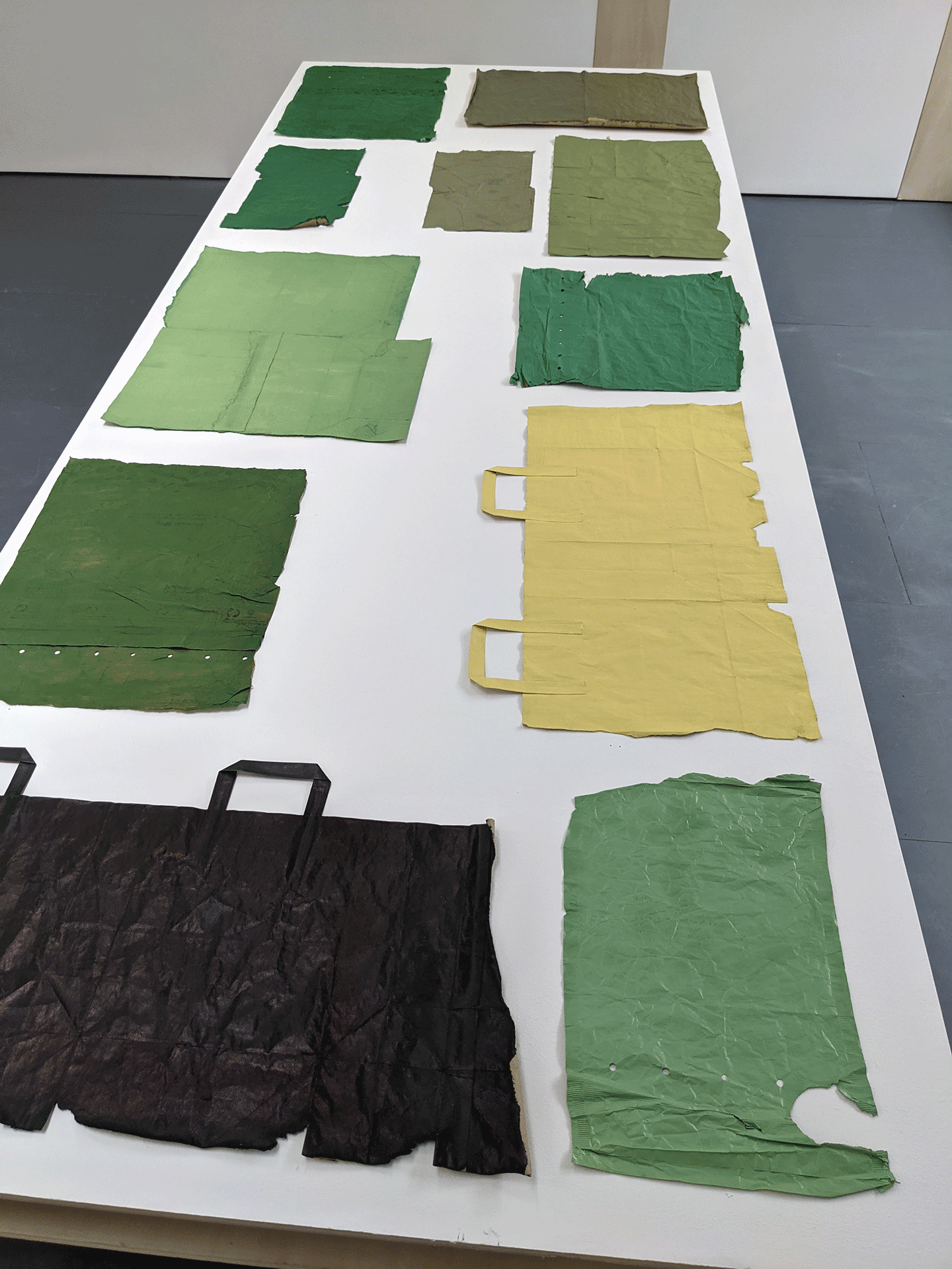Painted green paper bags, installation view