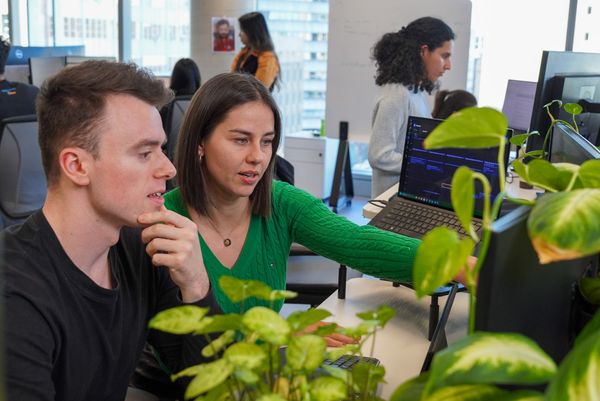 Paulina looks at computer screen with Joe