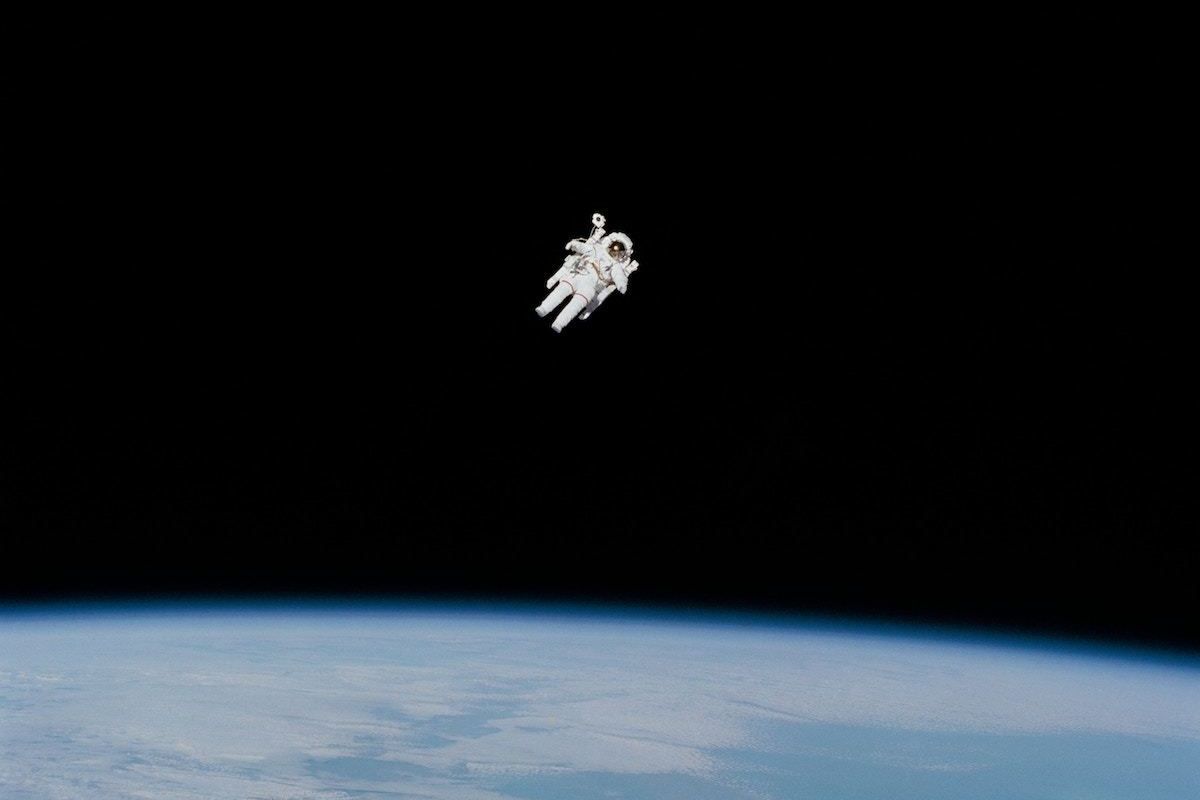 Astronaut in space above planet